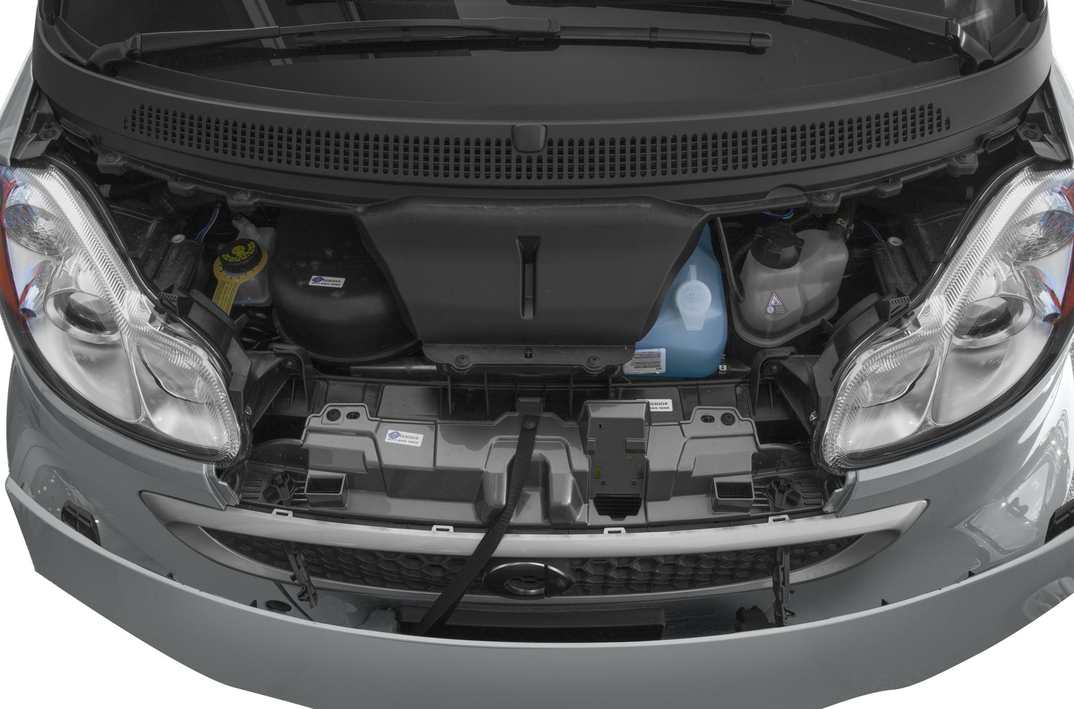Front engine compartment and headlights of a compact car