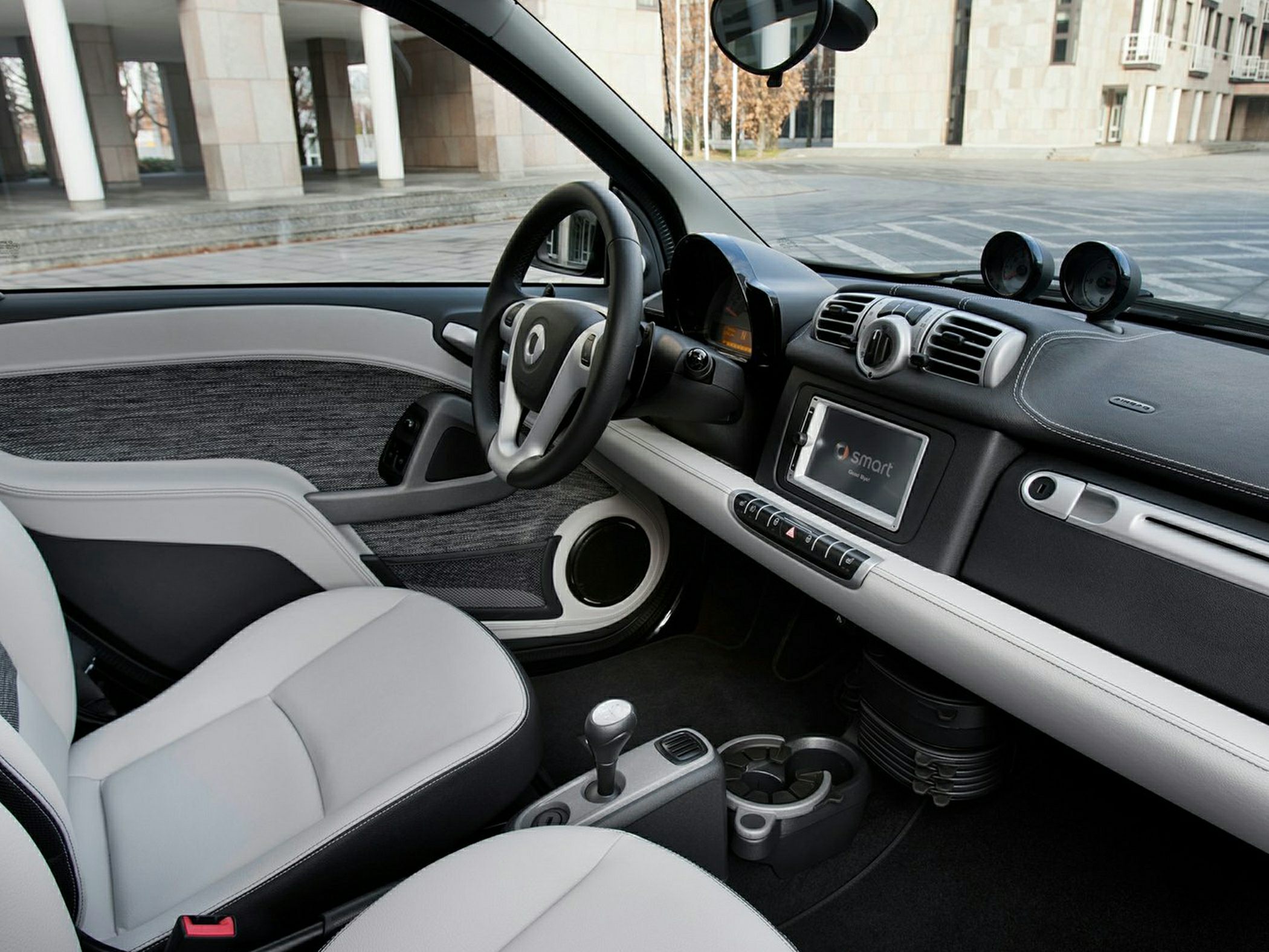 Compact car interior with modern dashboard and two front seats