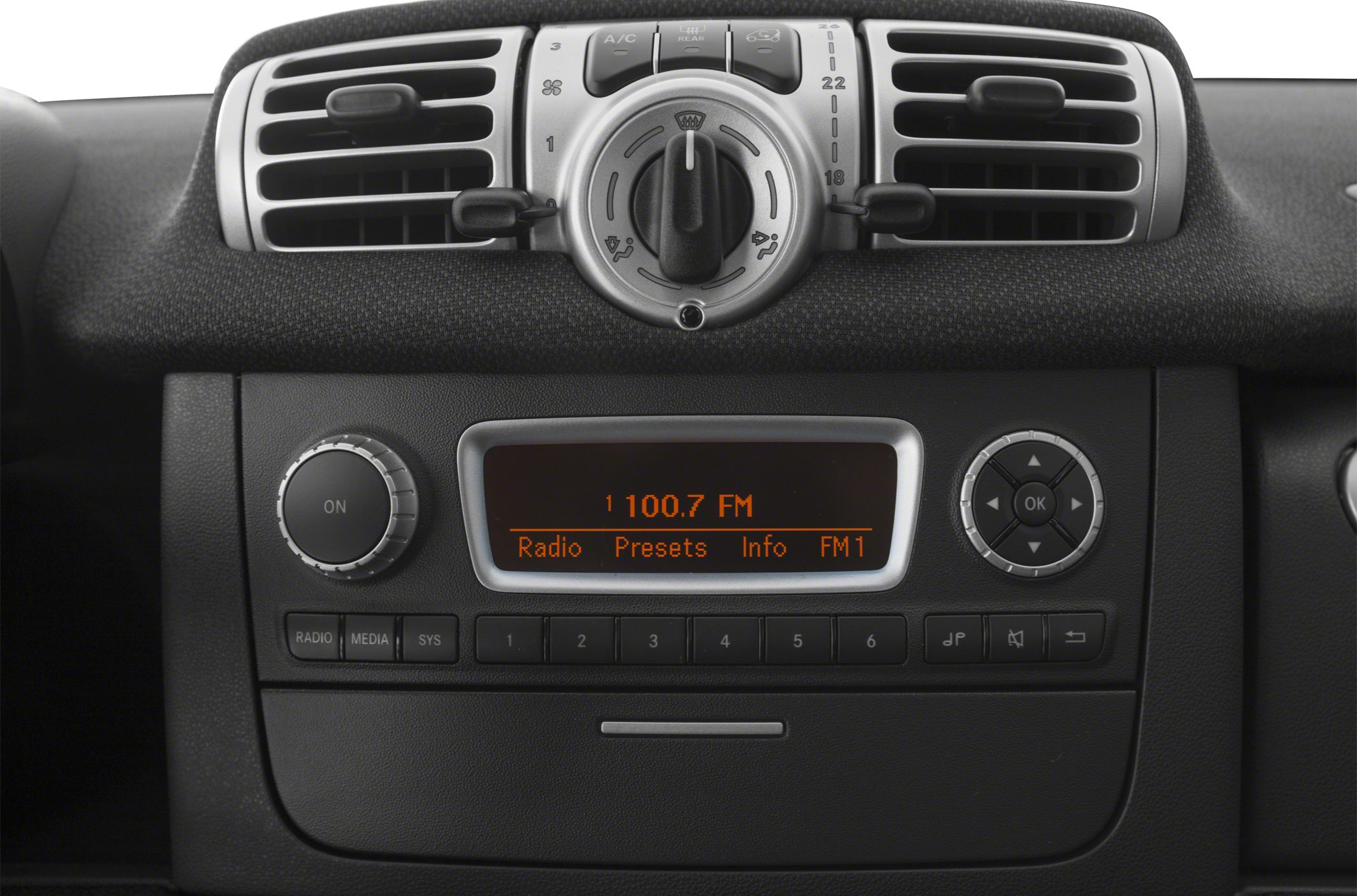 Car dashboard with climate control vents and digital radio display