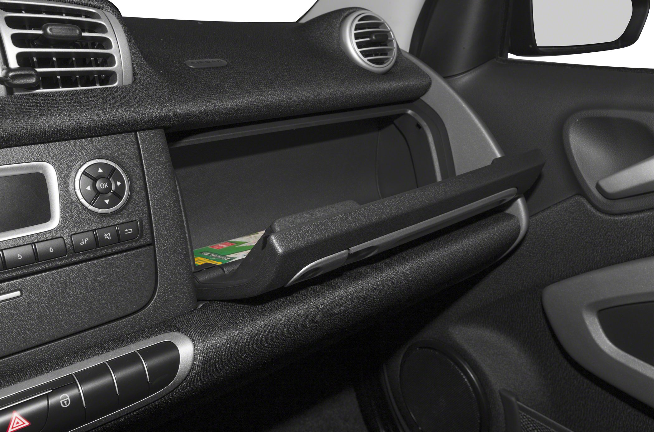 Open glove compartment and car dashboard with controls