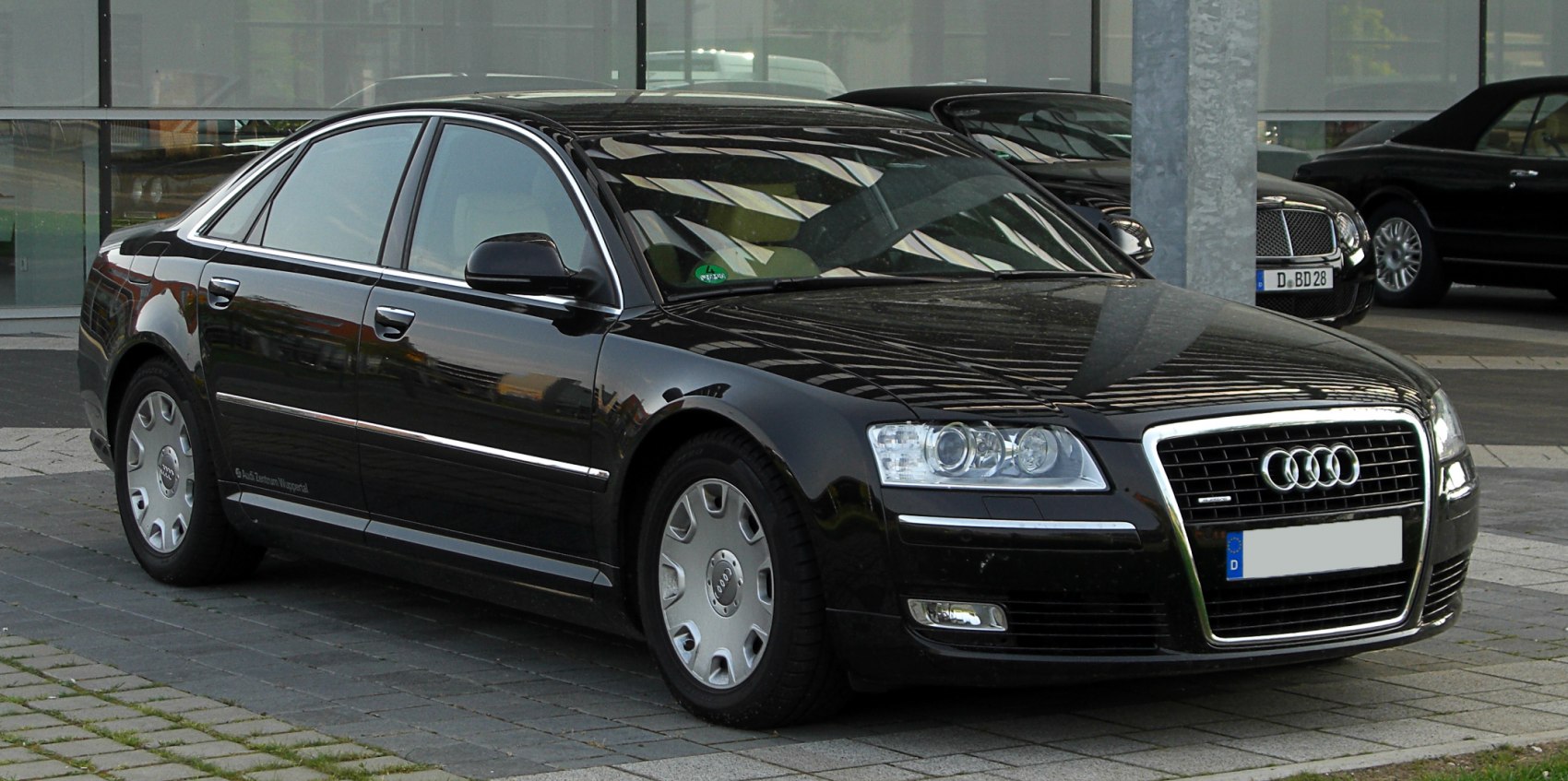 Luxury sedan with chrome grille and classic alloy wheels