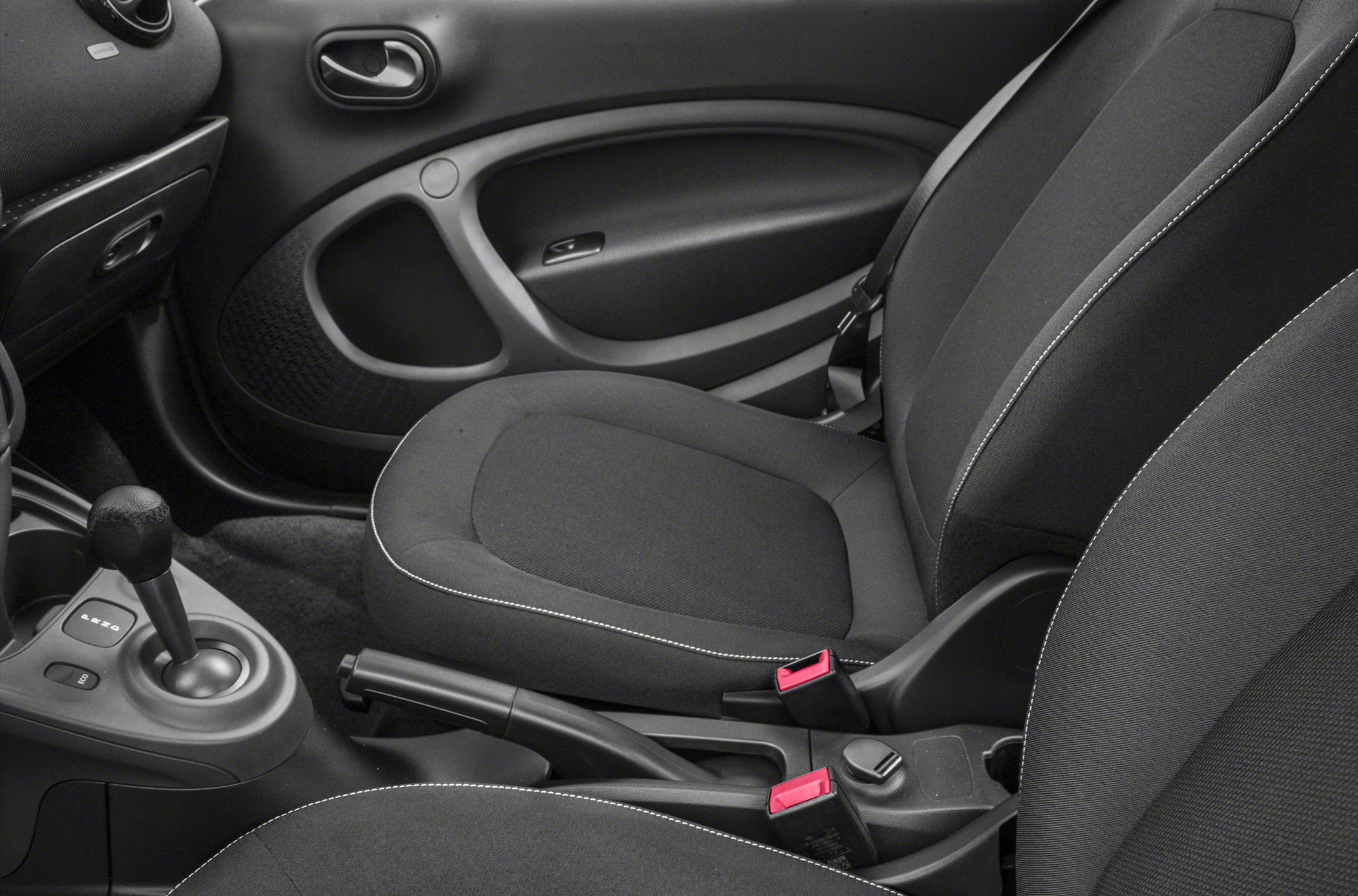 Gear lever, handbrake, fabric seats, and door panel interior details