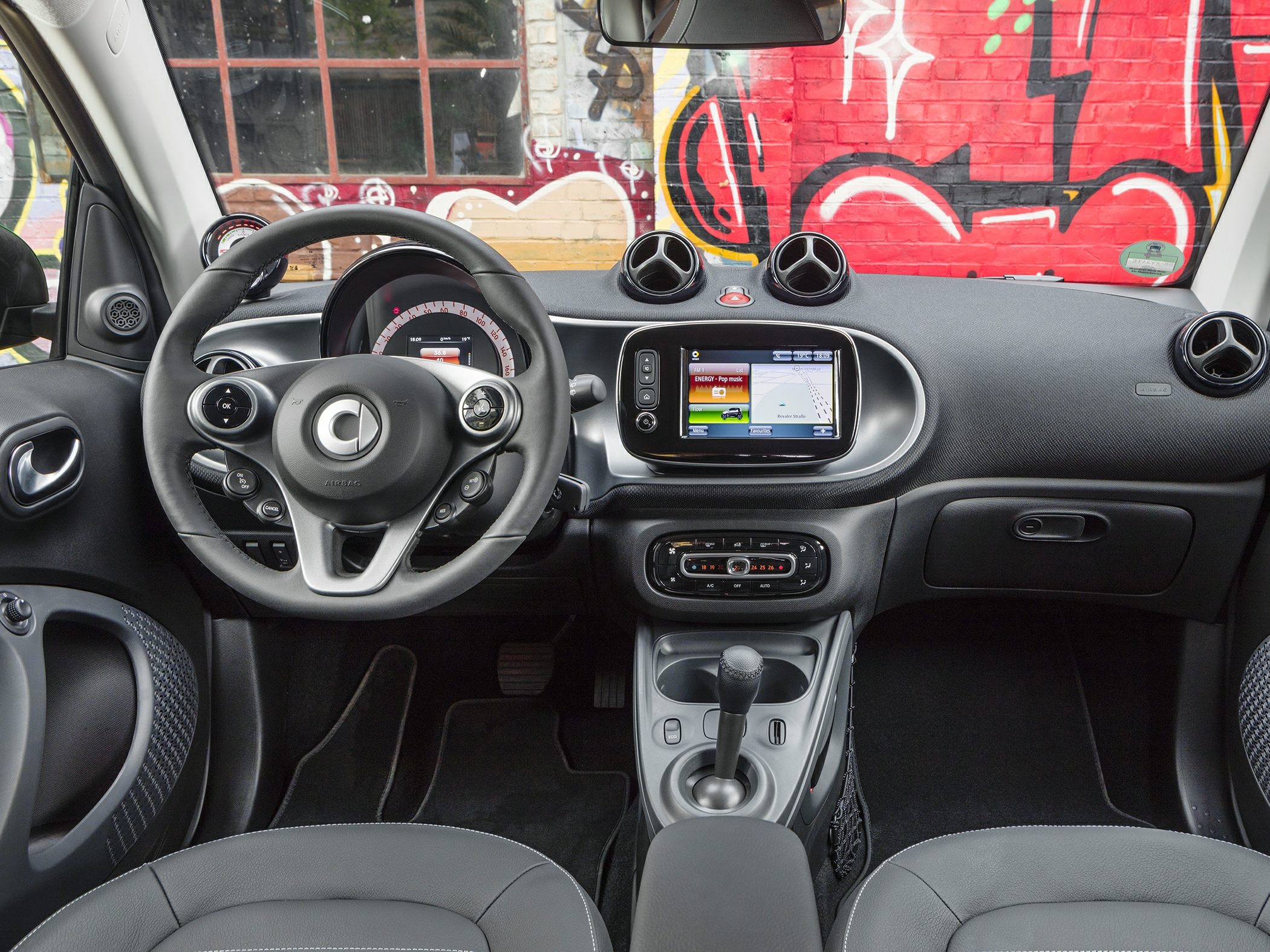 Dashboard and steering wheel with infotainment and climate controls