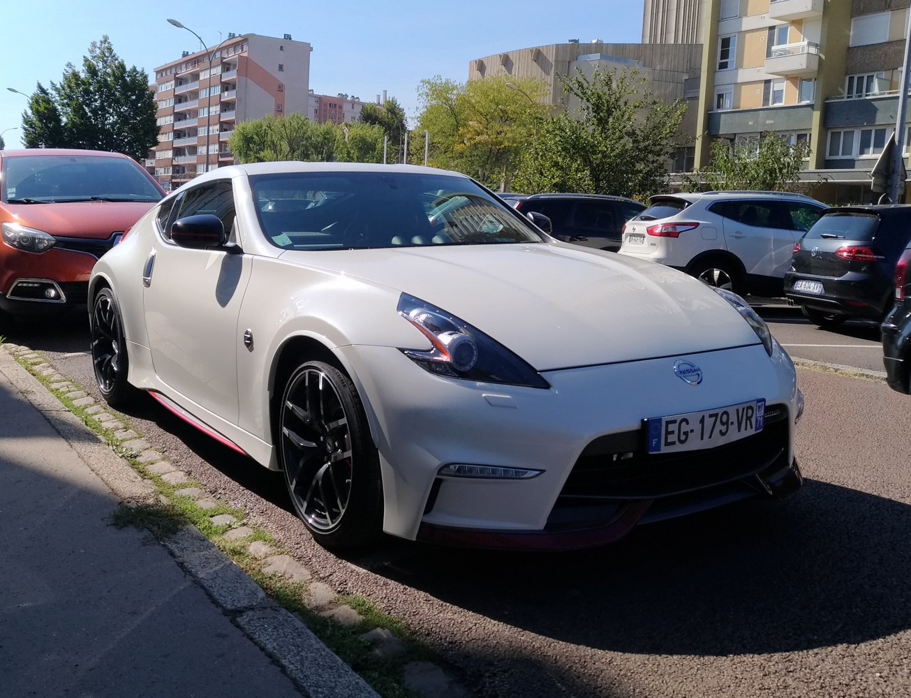 White sporty coupe with sleek headlights and black alloy wheels