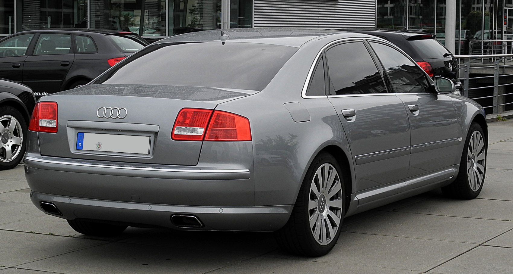 Luxury sedan rear view with dual exhaust and chrome trim