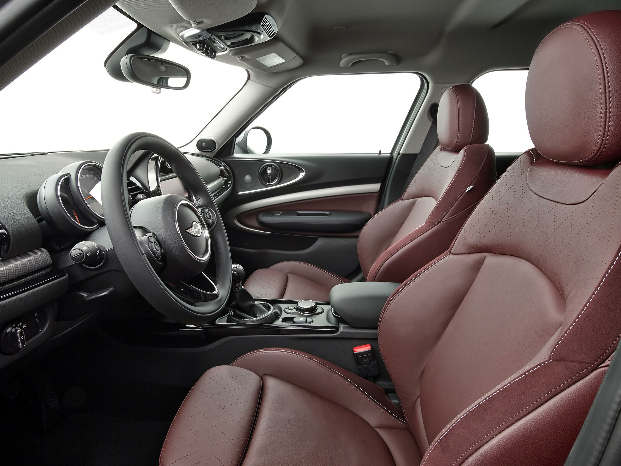 Premium brown leather seats and modern dashboard with steering wheel.