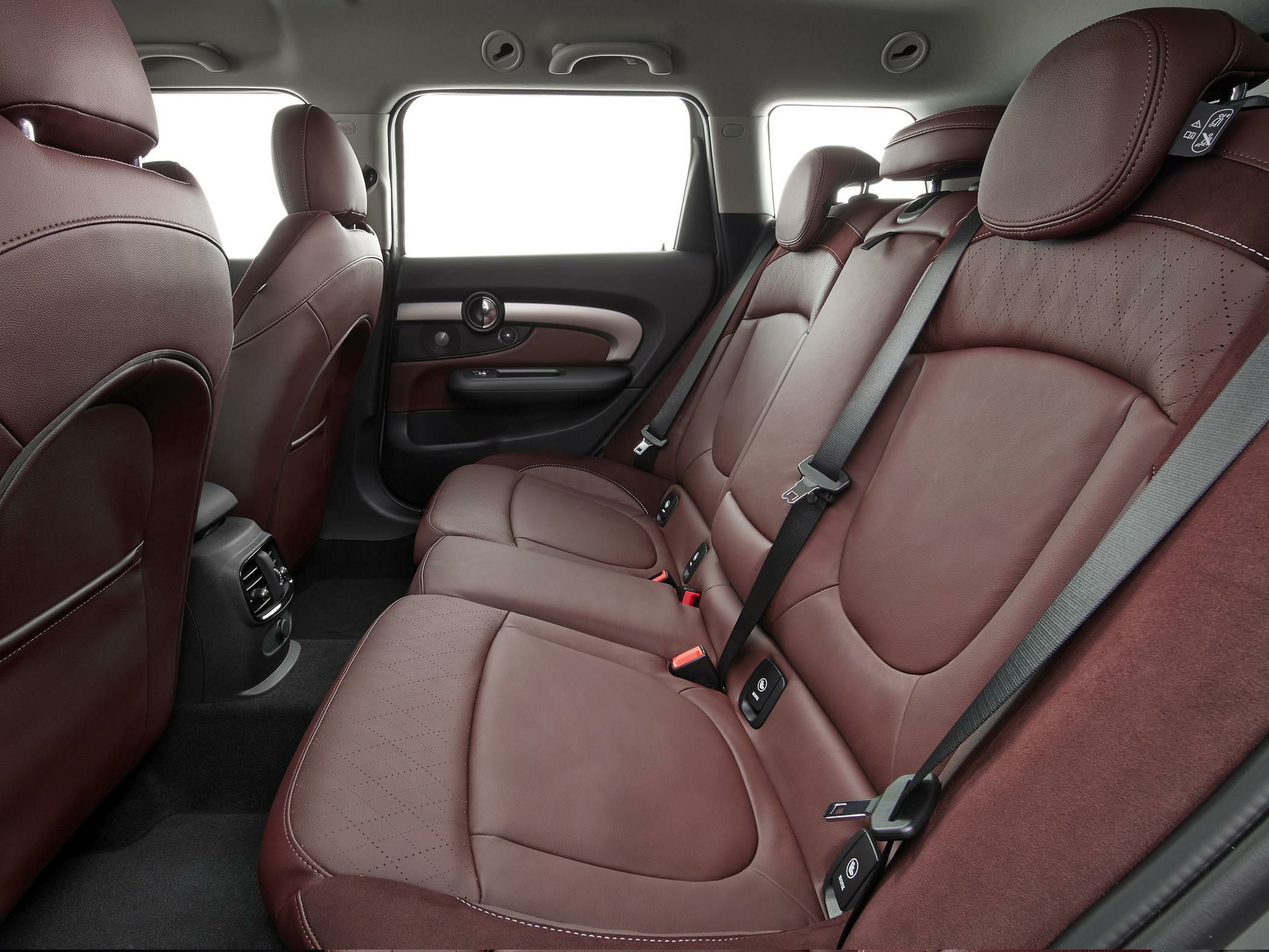 Brown leather rear seats with seatbelts and detailed upholstery