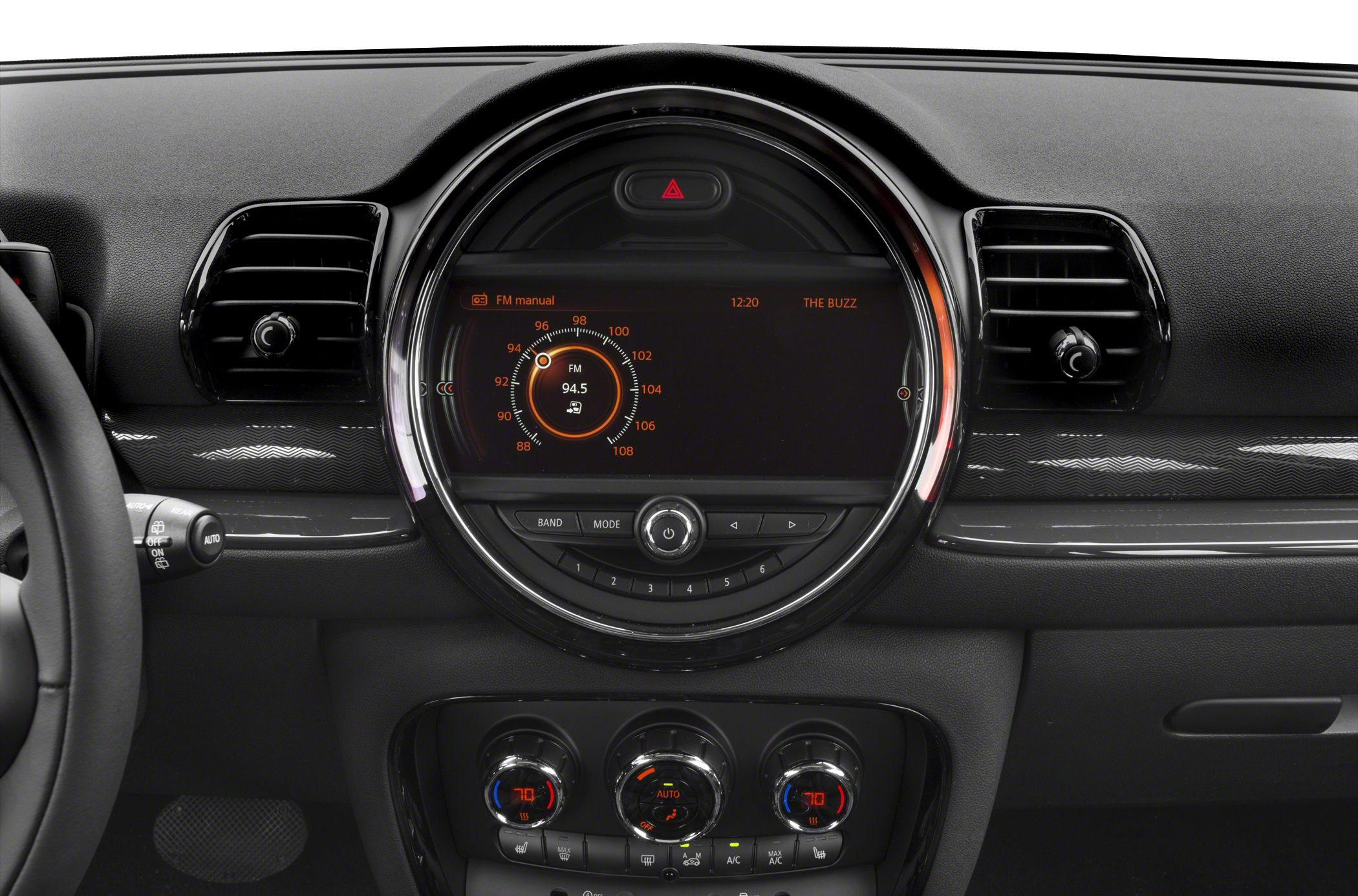 Dashboard with central circular infotainment display and climate control knobs