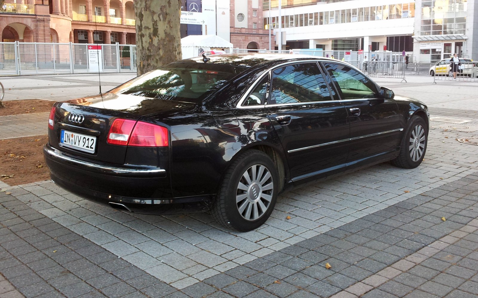 Rear side view of black luxury sedan with chrome trim and extended wheelbase