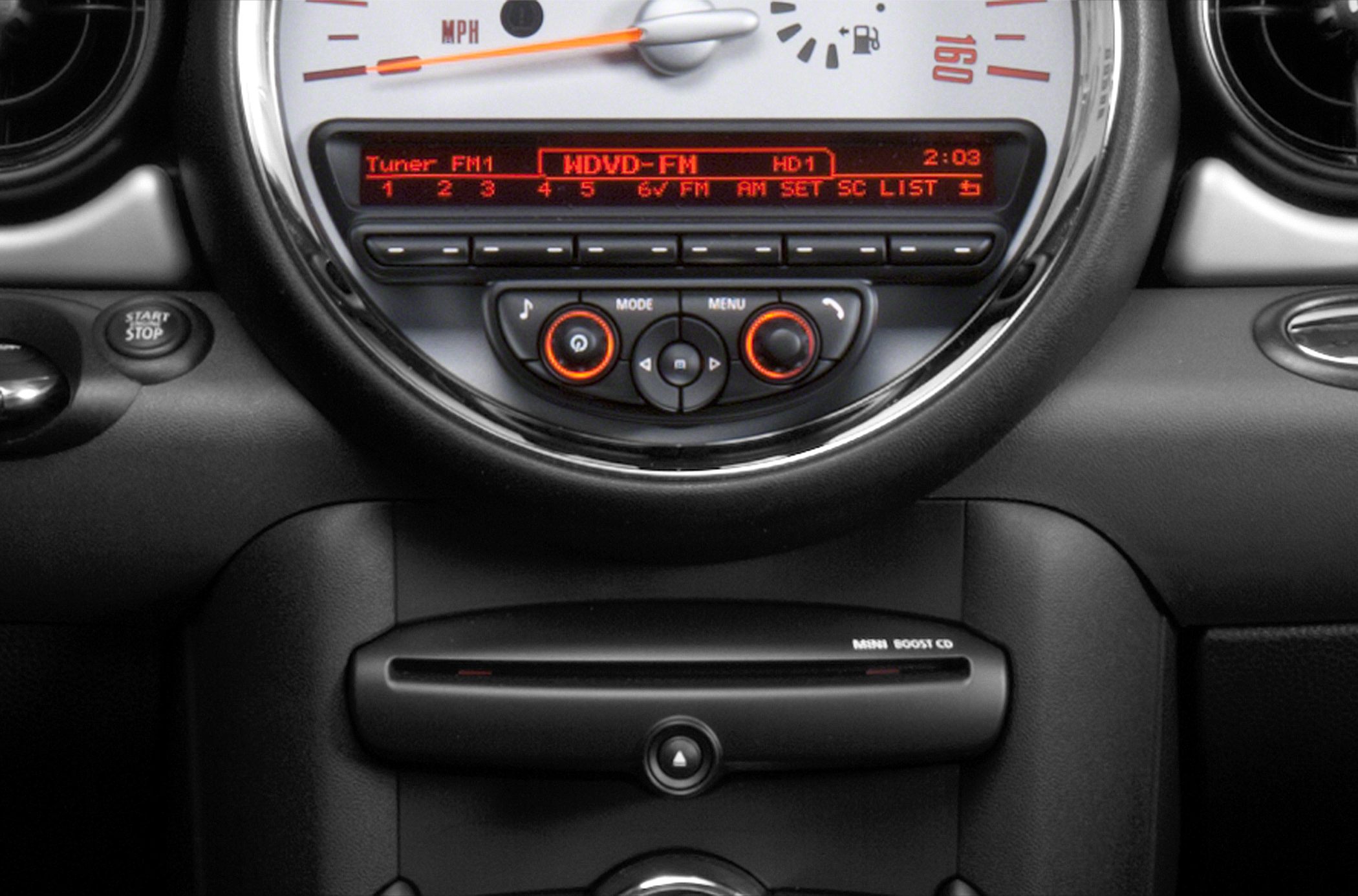 Car dashboard with speedometer, audio controls, and start/stop button