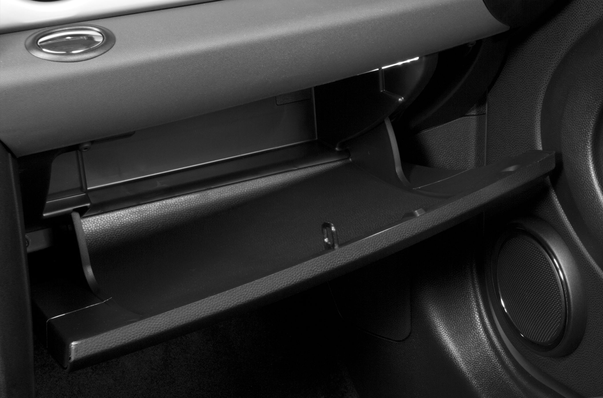 Open glove box and speaker inside car interior