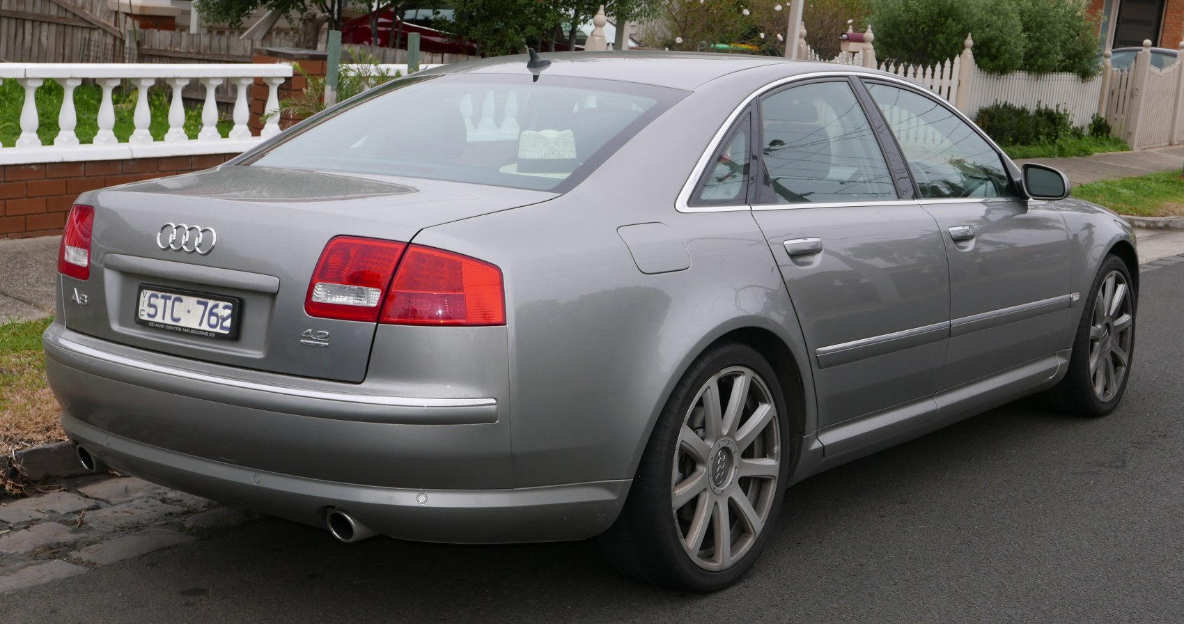 Silver luxury sedan rear side view with 4.2 Quattro badge and alloy wheels