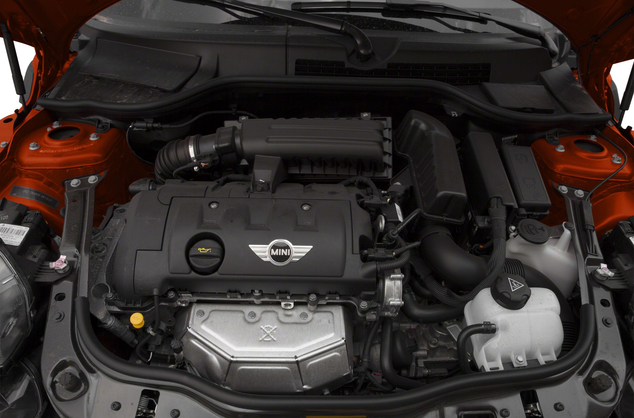 Engine bay with engine cover, air intake, and cooling reservoir