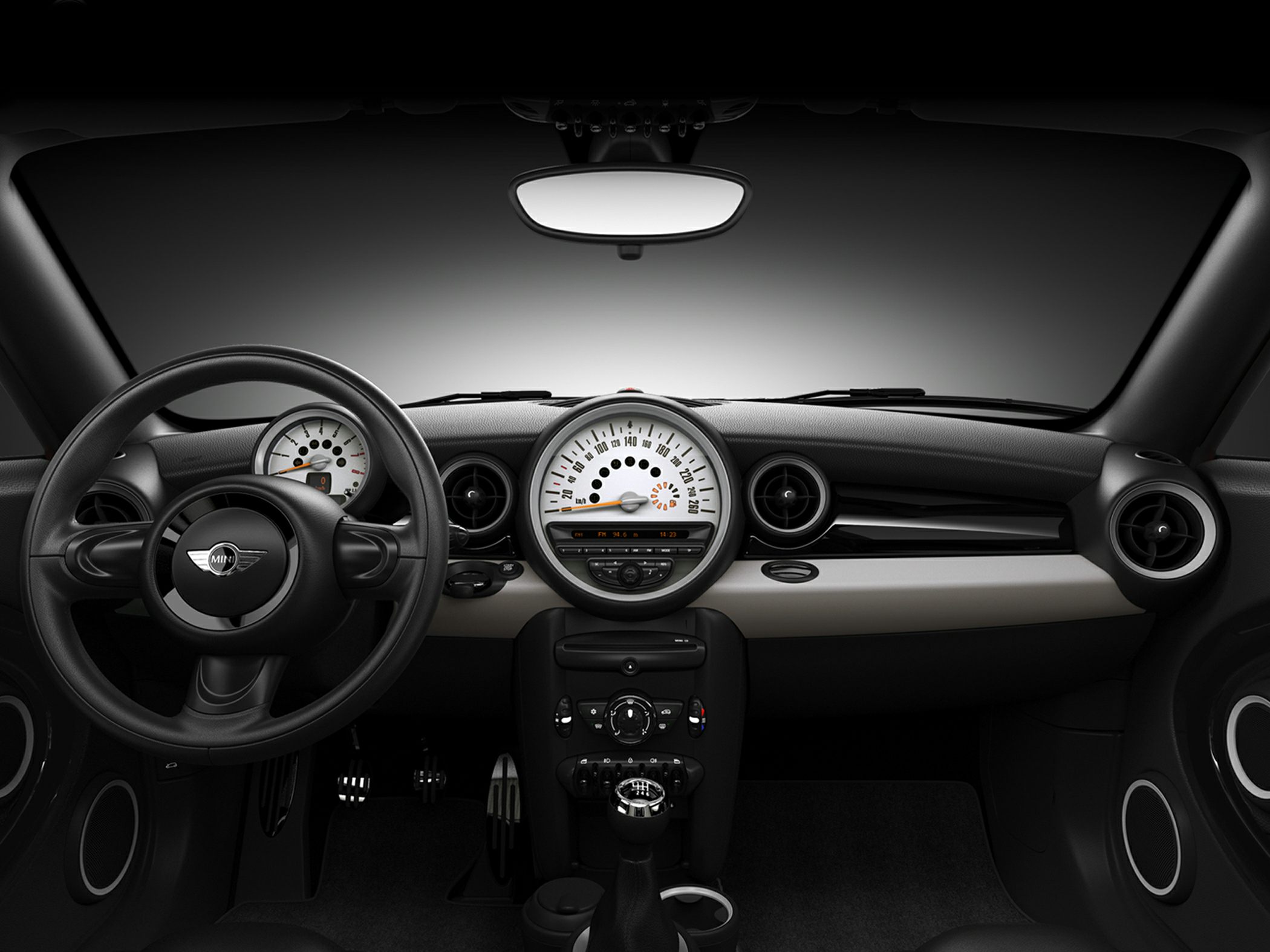 Car interior dashboard with central speedometer and round air vents