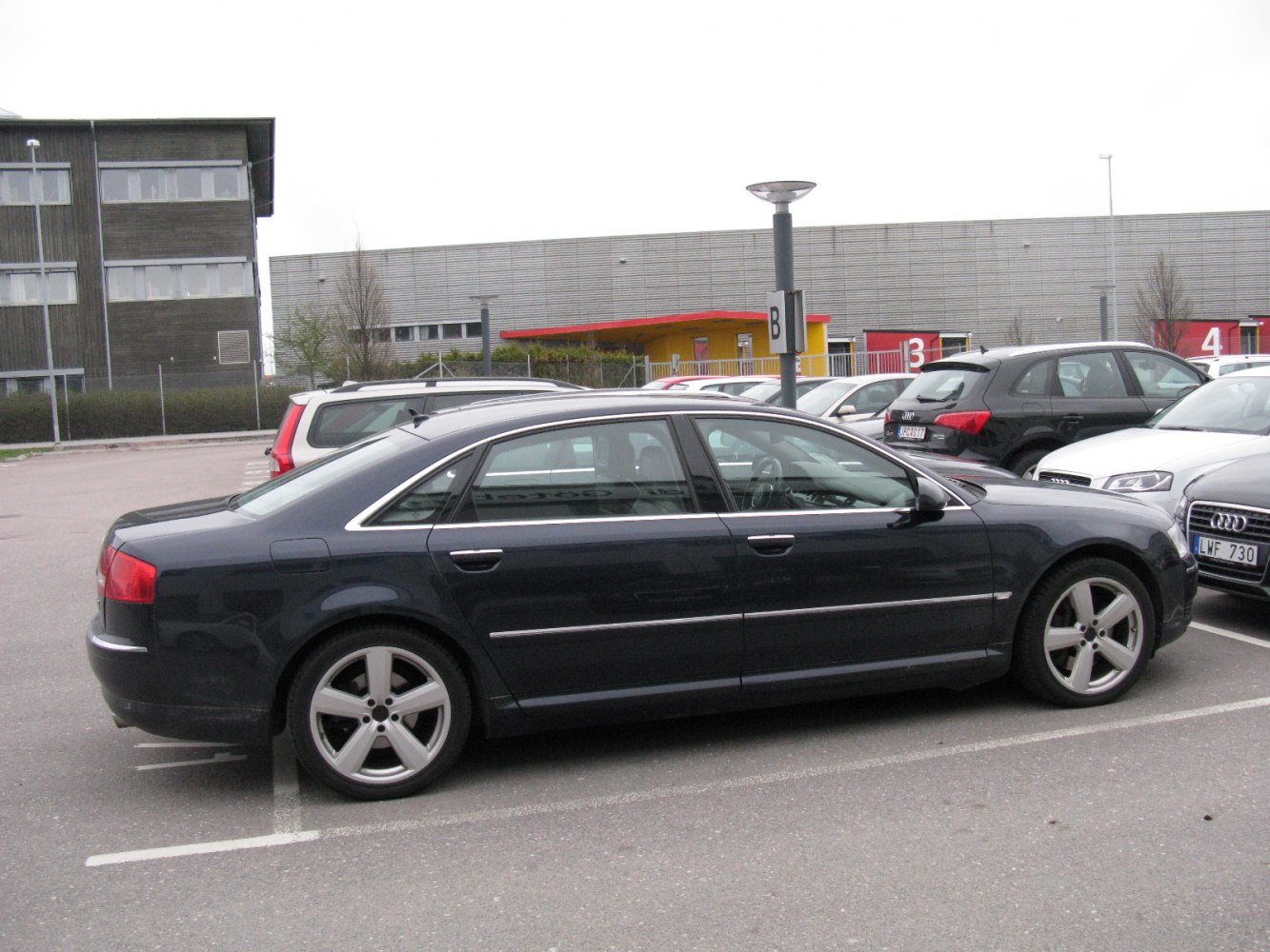 Luxury sedan side view with extended wheelbase and alloy wheels