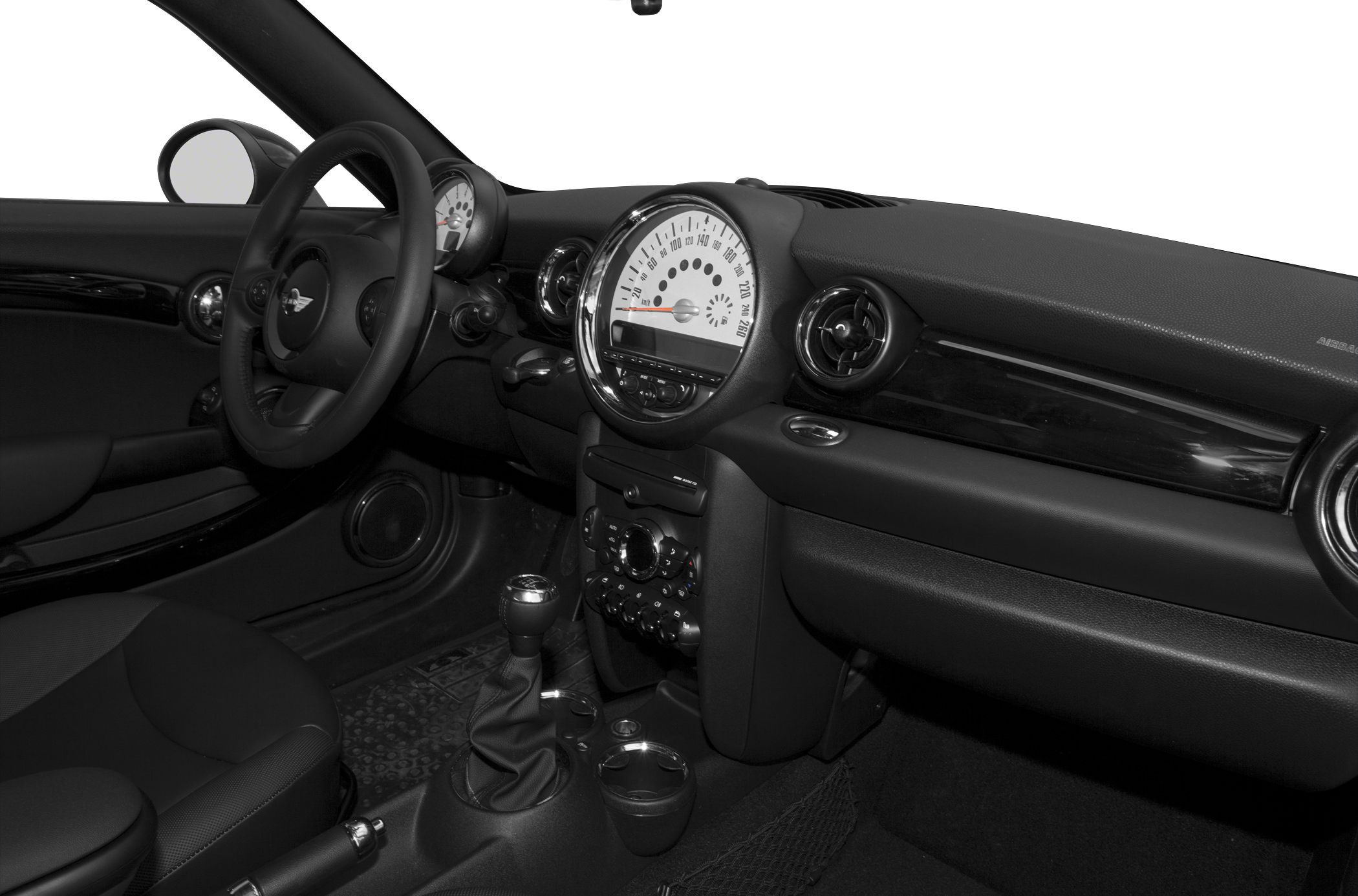 Central round speedometer, dashboard, manual gear stick in compact interior