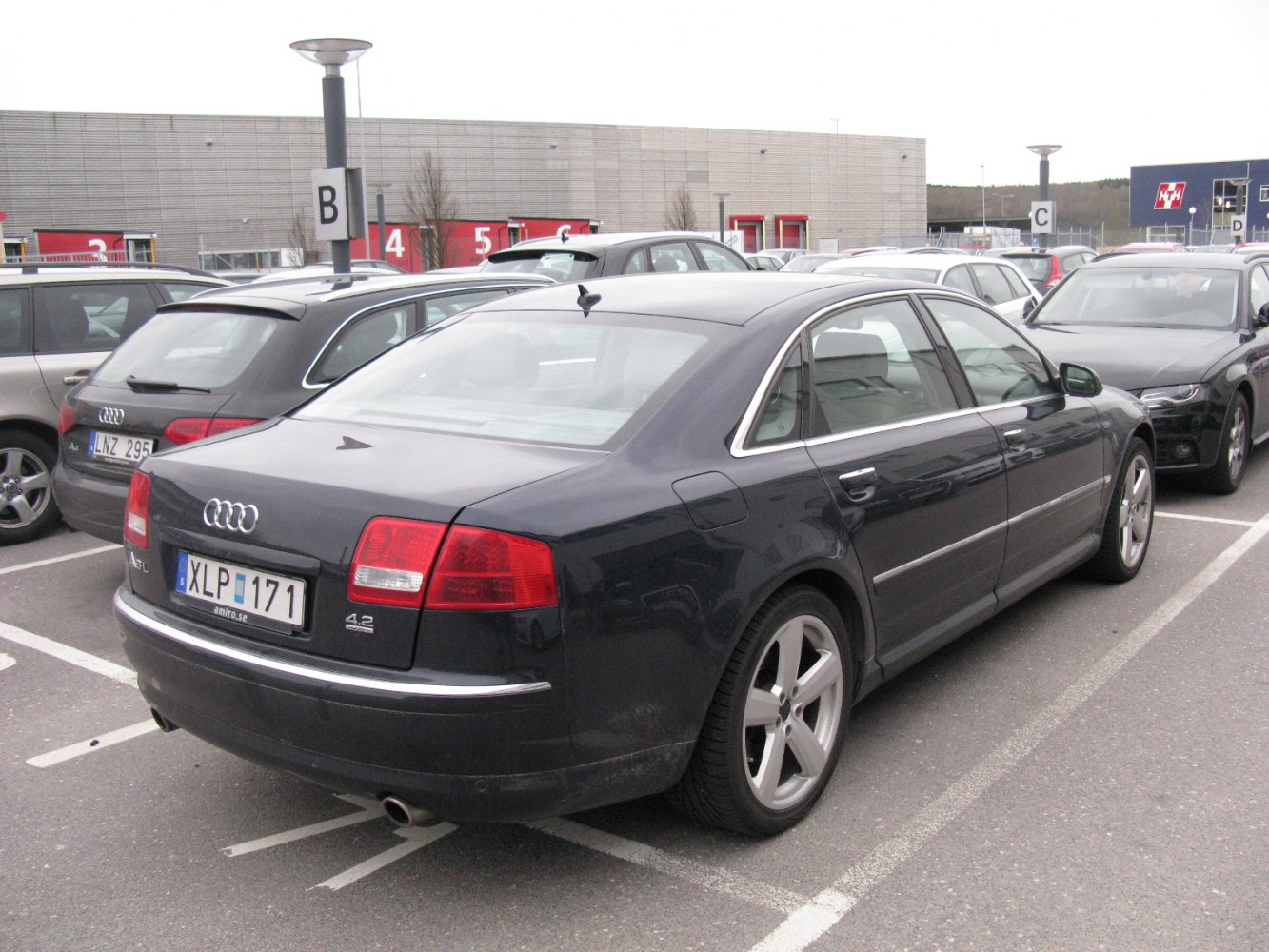 Rear side view of luxury sedan with chrome trim and alloy wheels