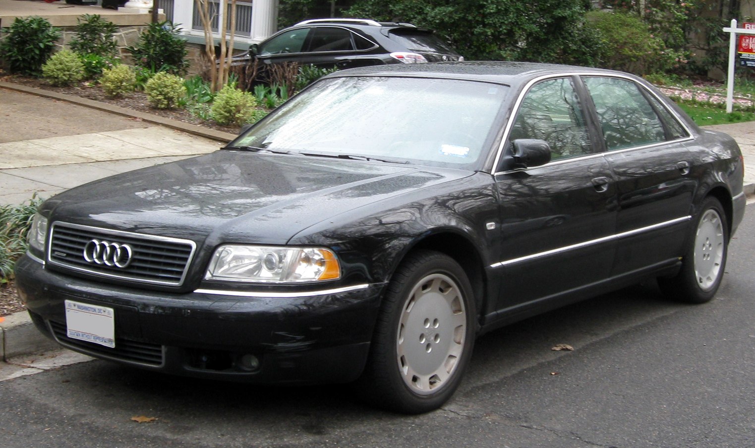 Front and side view of a classic luxury sedan with distinct grille and headlight design