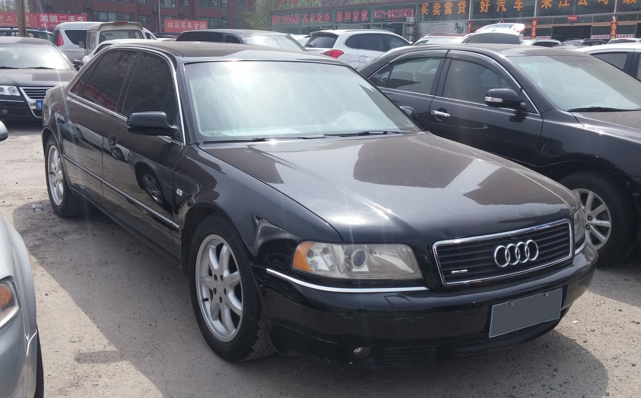 Front-right view of black luxury sedan with alloy wheels and tinted windows