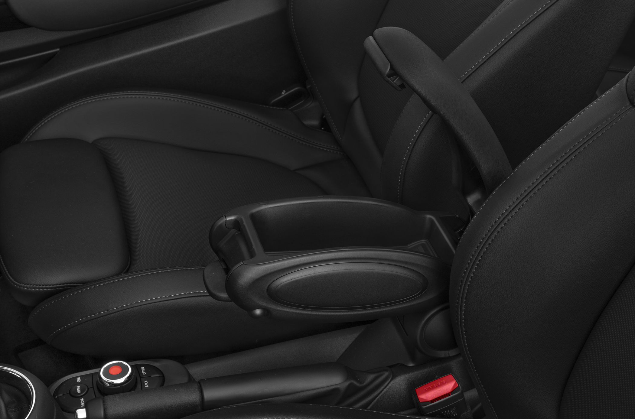 Close-up of center console armrest and control buttons in car interior