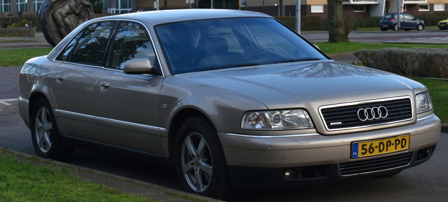 Front side view of a luxury sedan with classic grille and headlights
