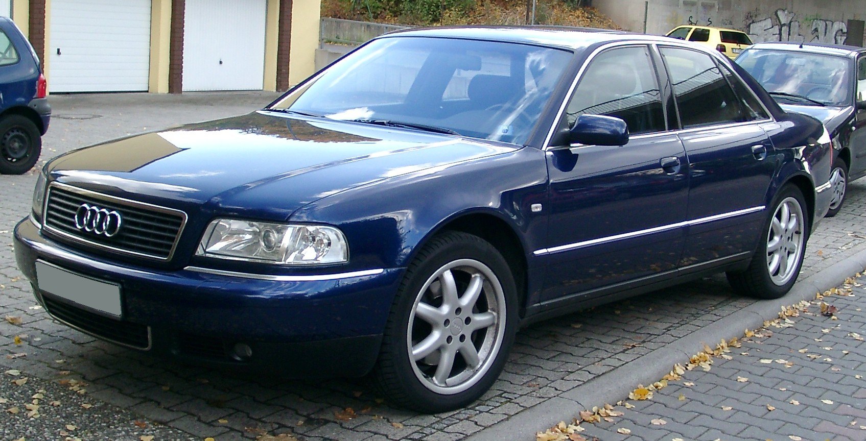 Front side view of luxury sedan with headlight and alloy wheel design
