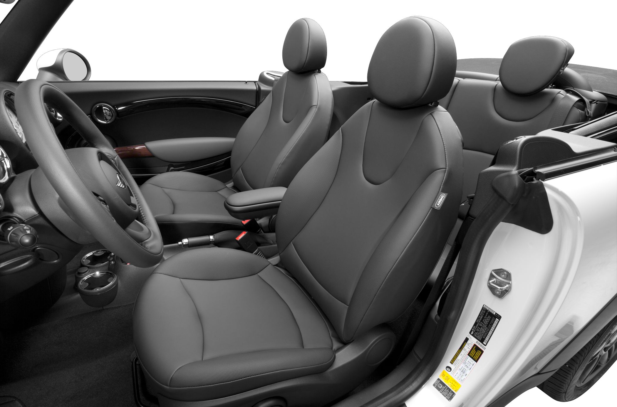 Front seats, steering wheel, and door panel of a compact convertible interior