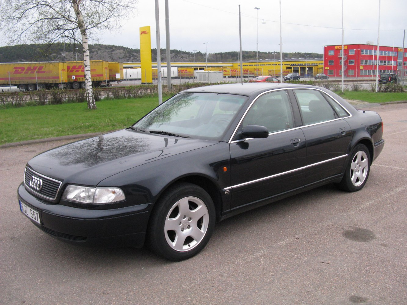 Front side view of a 1990s sedan with alloy wheels