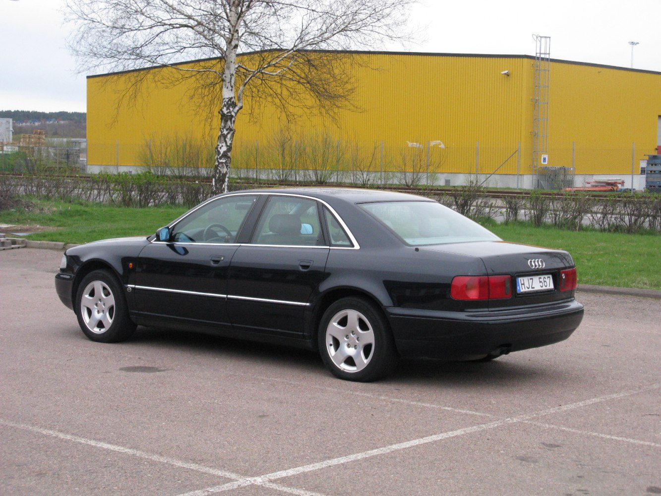 Black luxury sedan rear side profile with distinct rear lights.