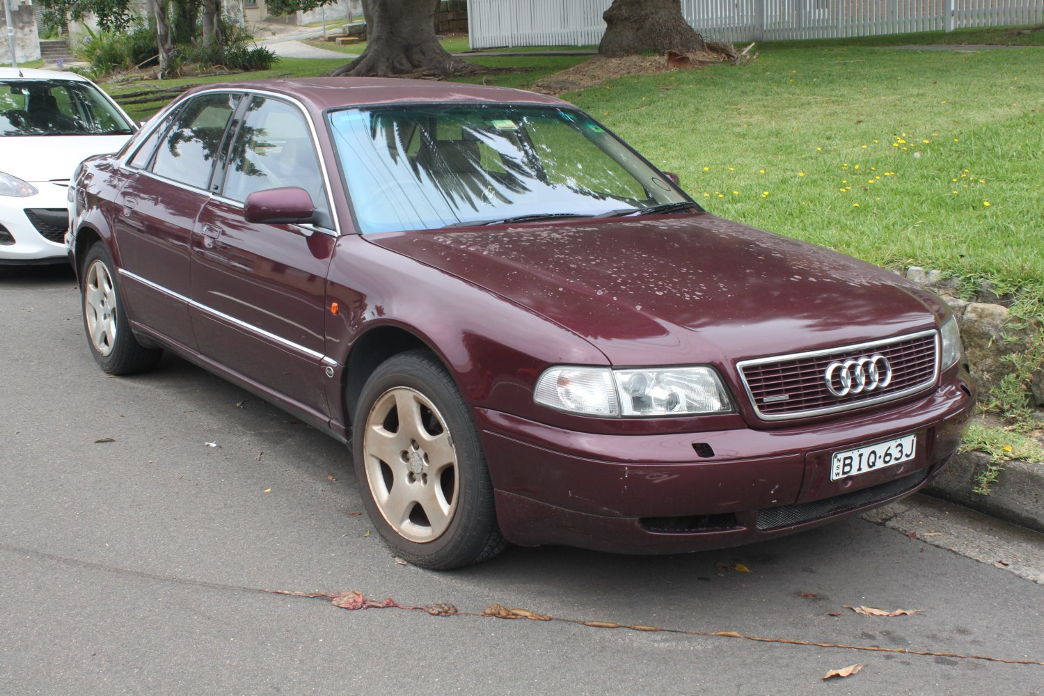 Classic luxury sedan front-side view with distinctive grille and alloy wheels