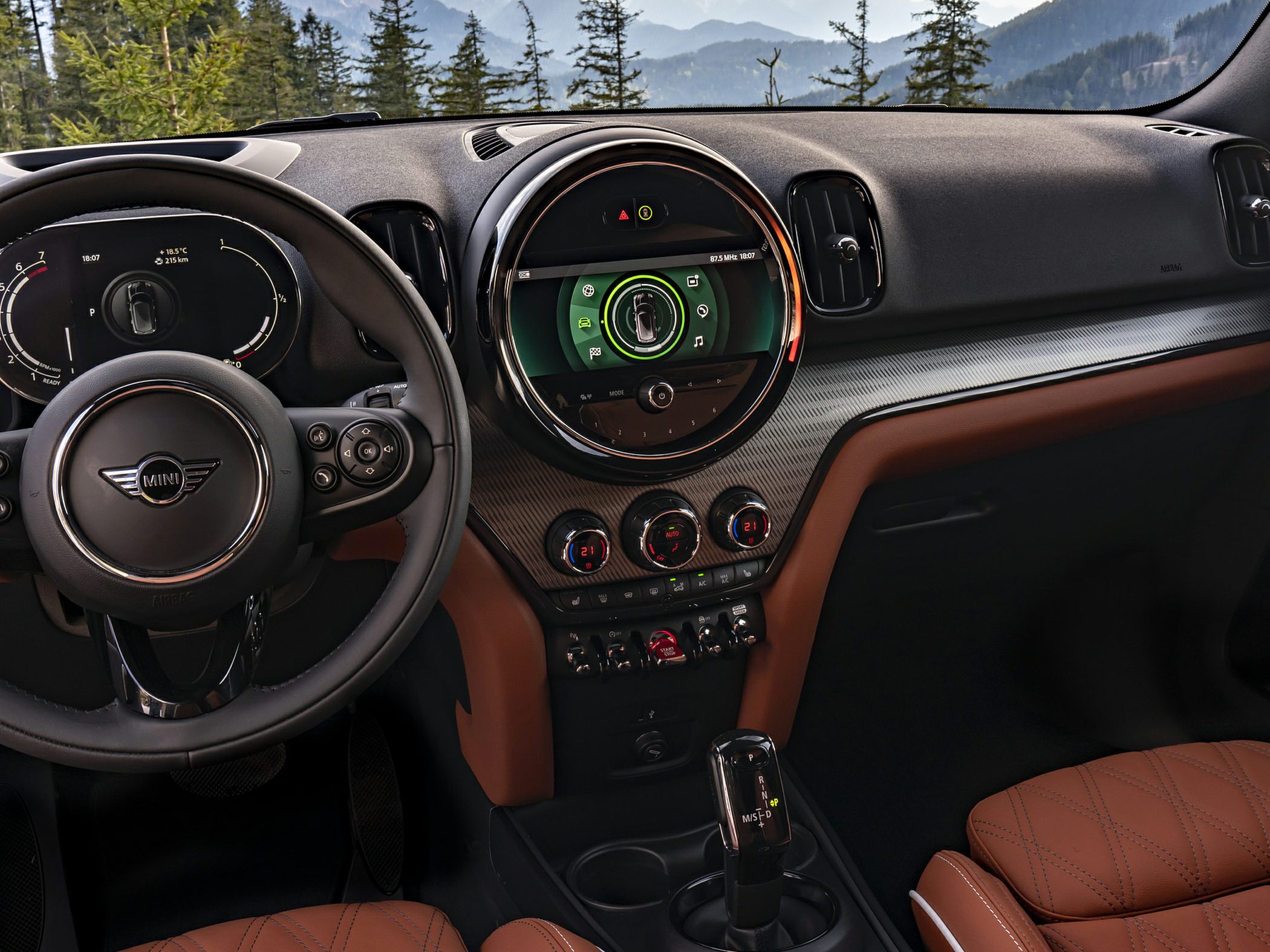Modern dashboard with central digital display and brown leather seats.