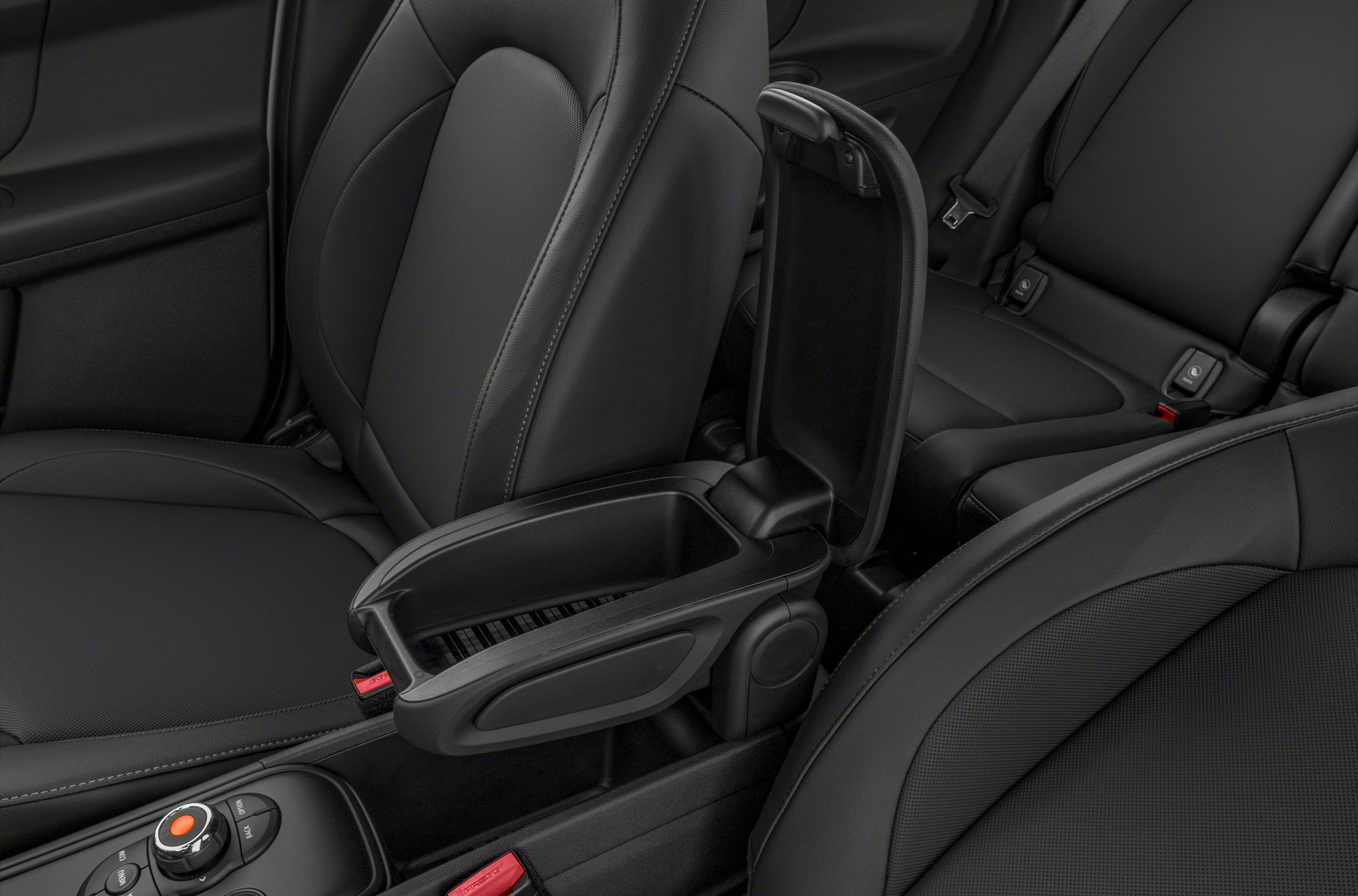 Open center console storage with black leather car seats.