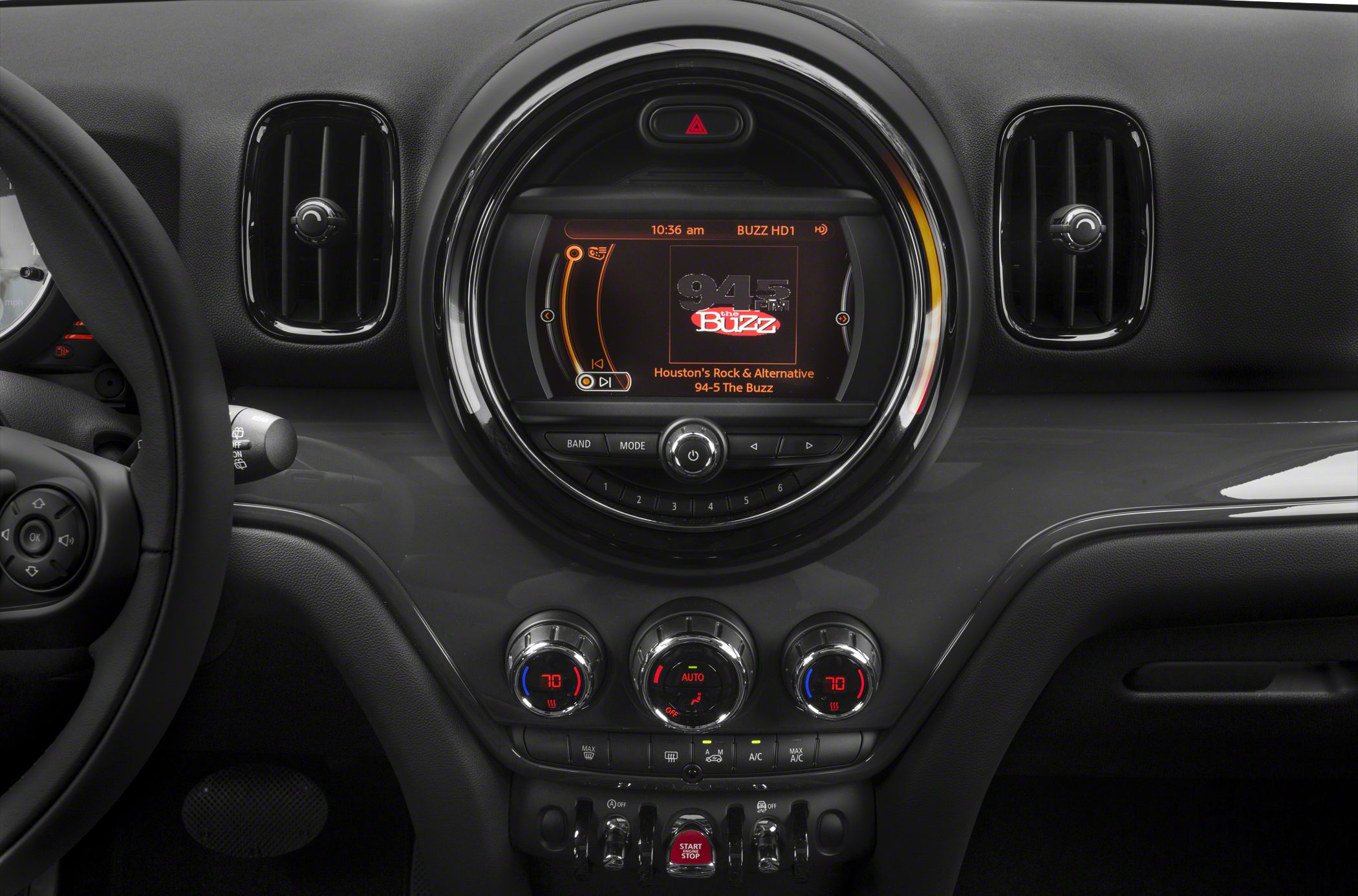 Round central infotainment display, climate control dials and air vents