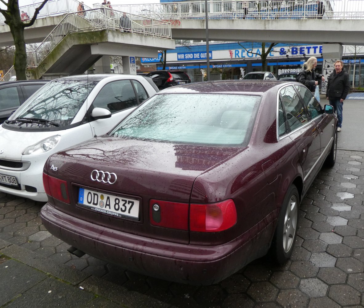Rear view of a luxury sedan with distinct rectangular taillights and tinted rear window.