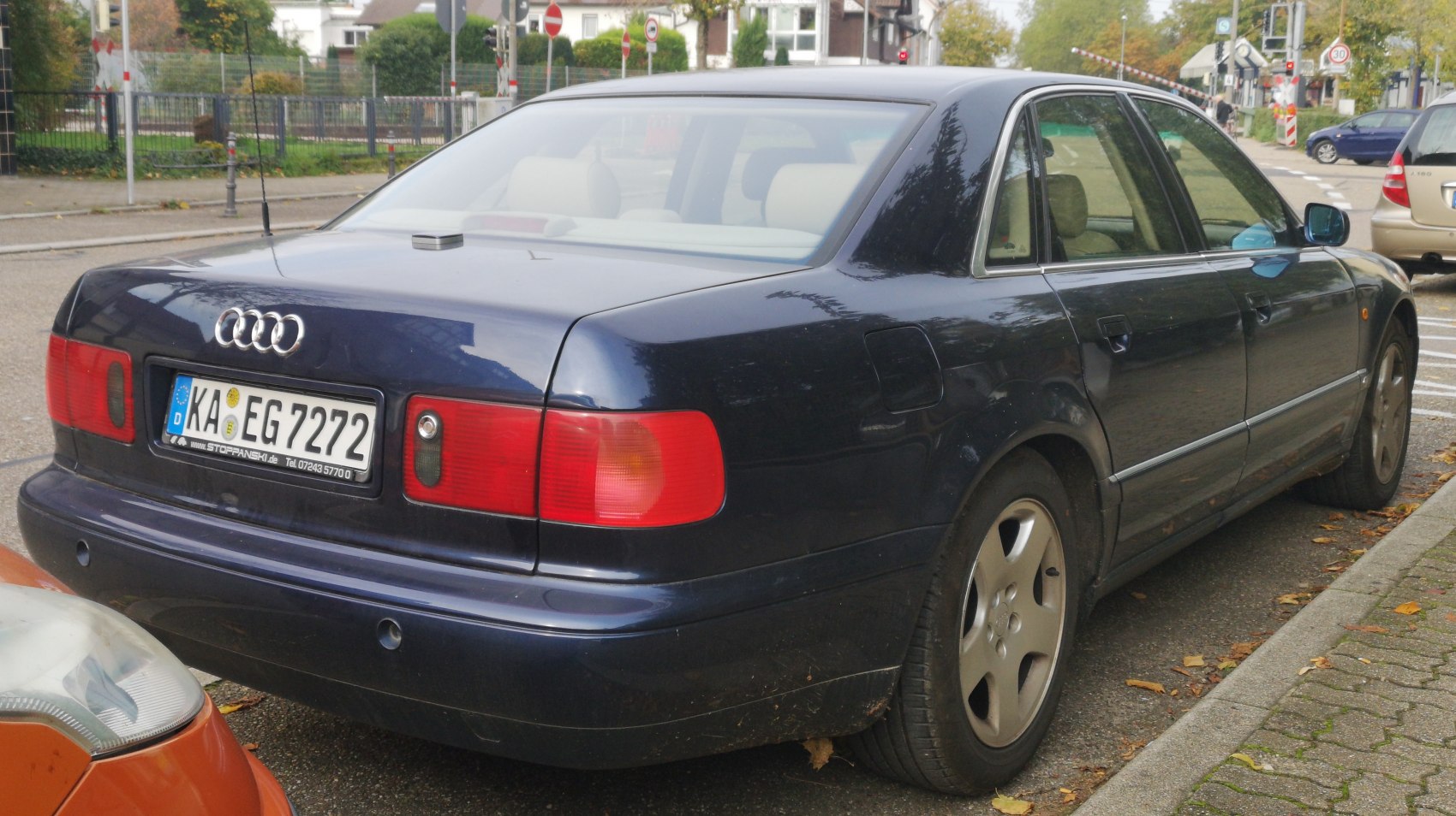 Rear side view of a classic luxury sedan with distinct tail lights and alloy wheels