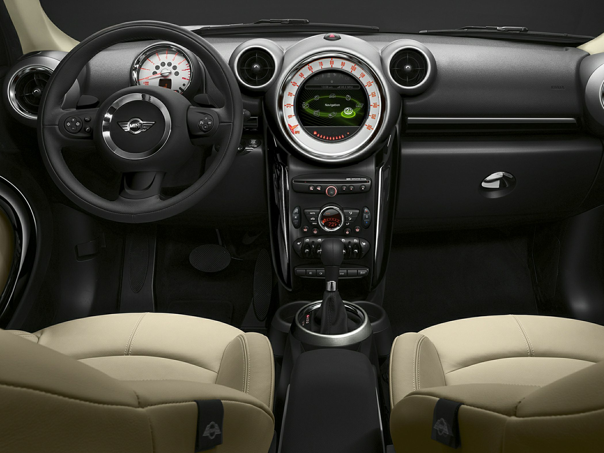 Round dashboard with central navigation and beige leather seats