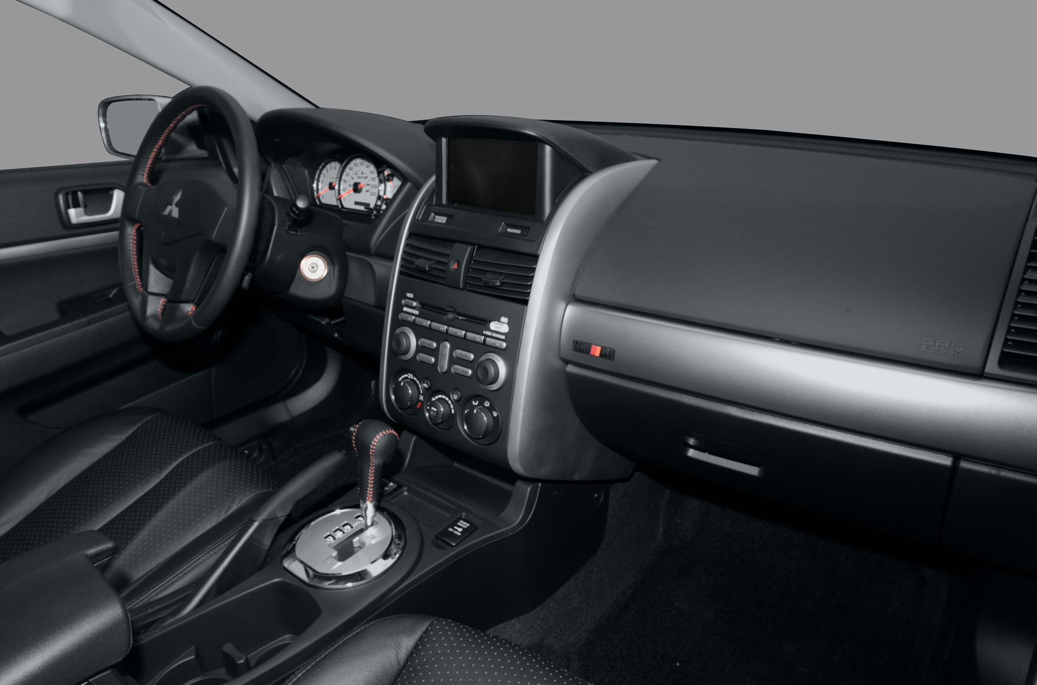 Interior view of dashboard, steering wheel, and automatic gearshift