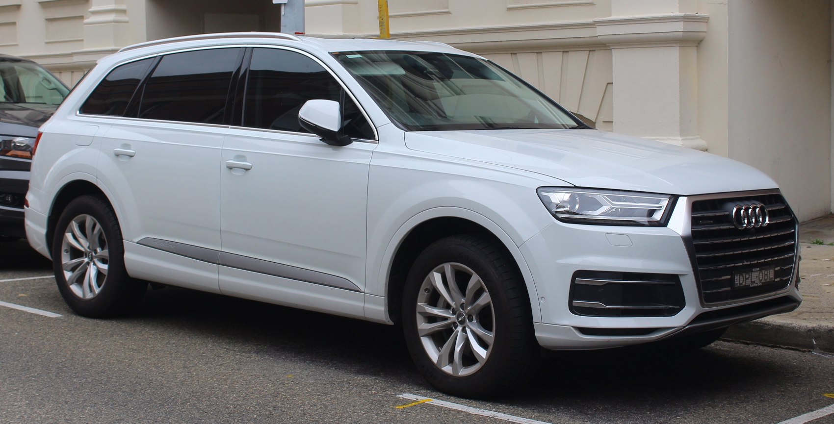 Front side view of a white SUV with LED headlights and alloy wheels