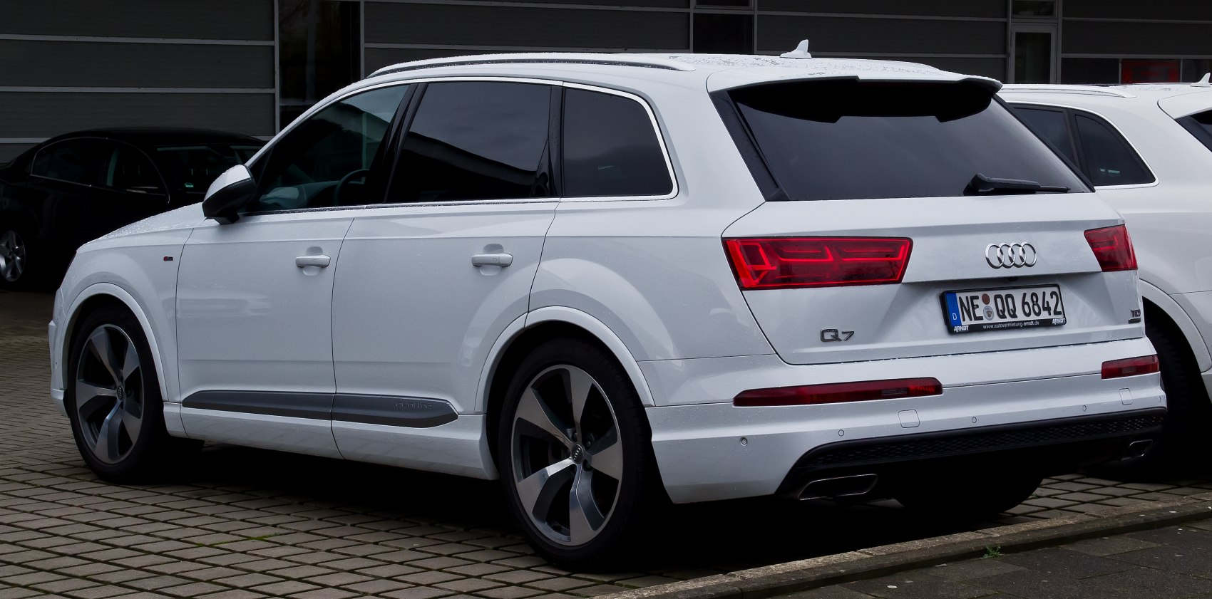 Rear side view of a modern white SUV with LED taillights and alloy wheels