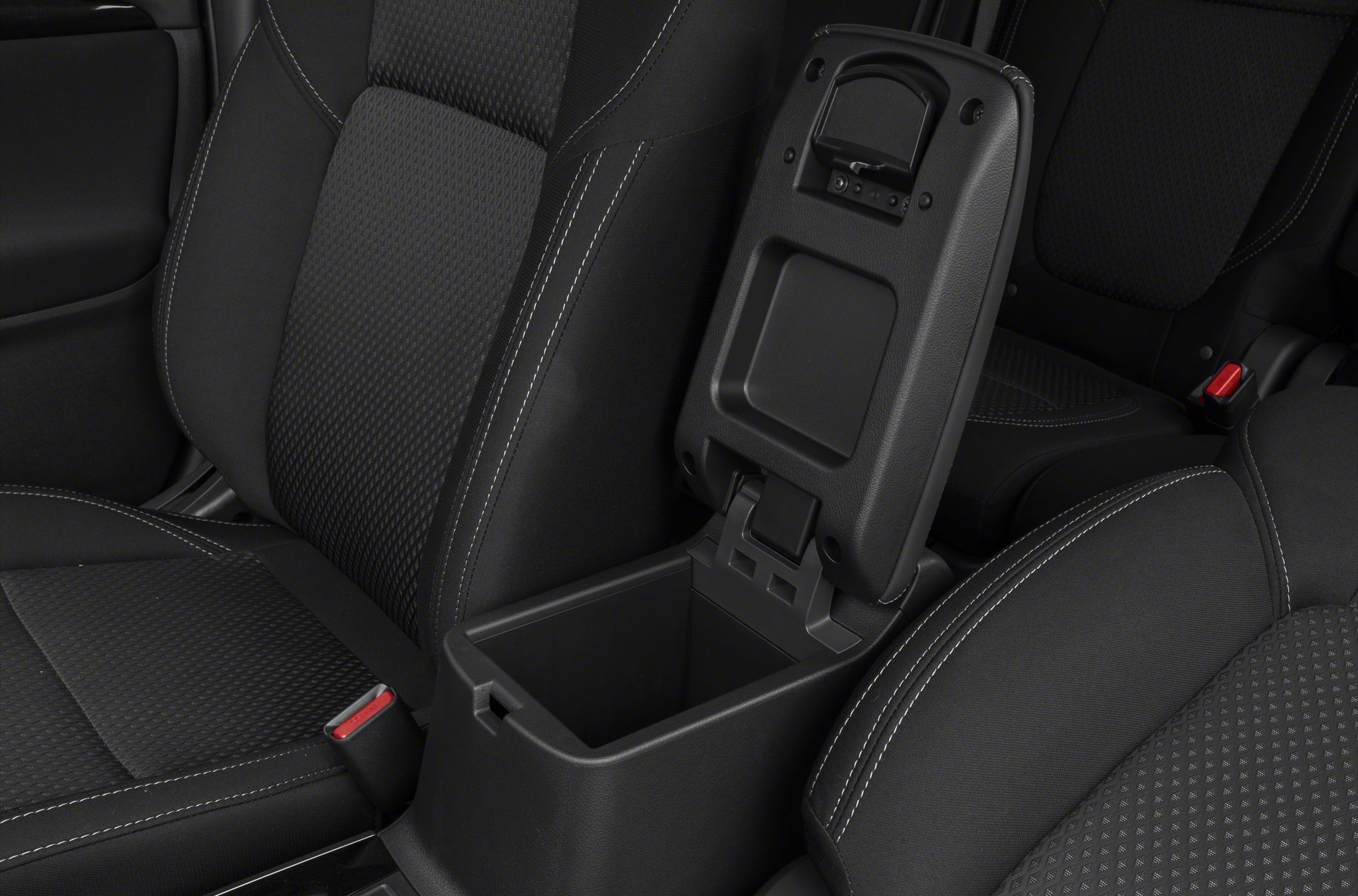 Open center console storage compartment between front seats with detailed upholstery