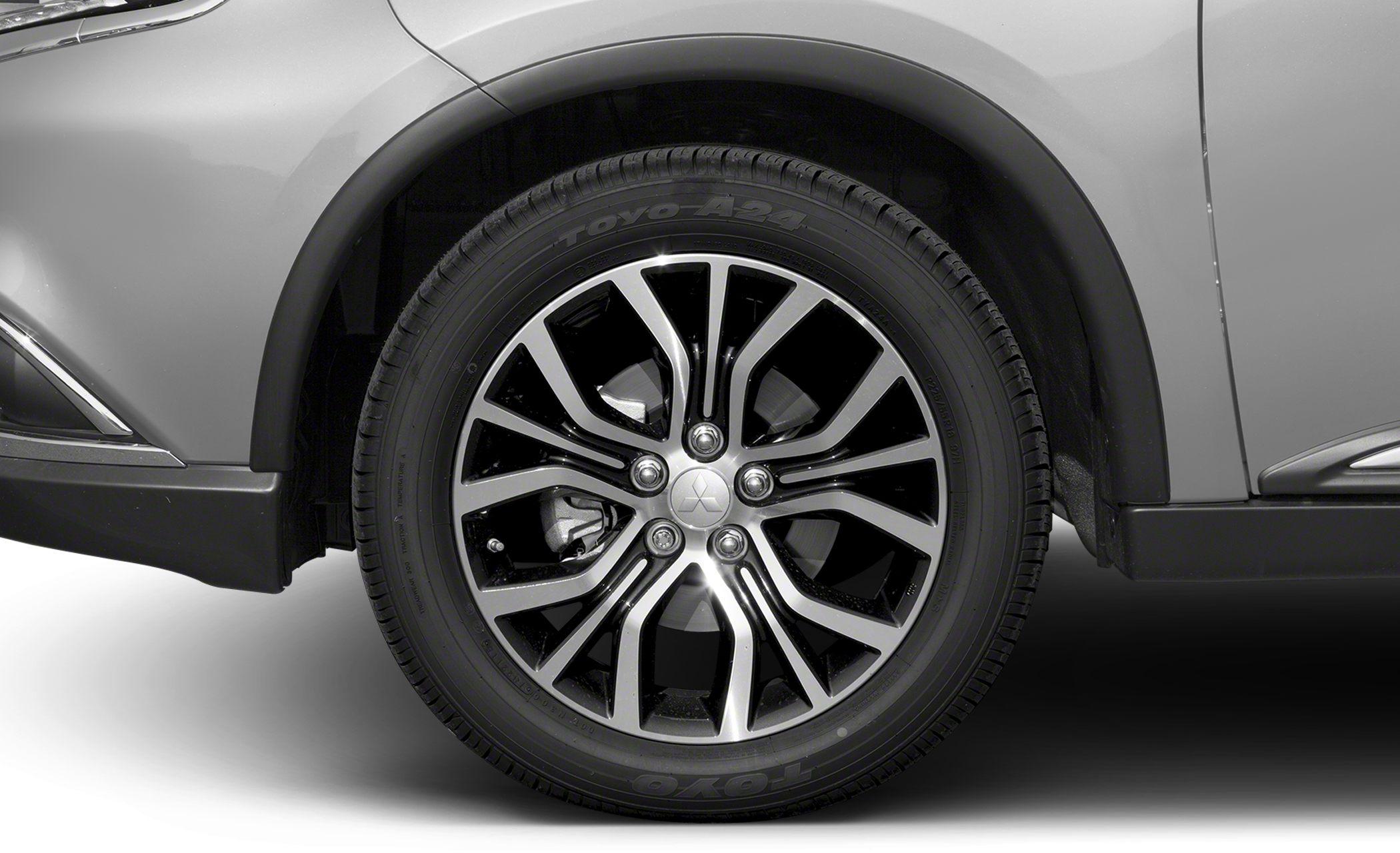 Alloy wheel with intricate spoke design and tire detail.