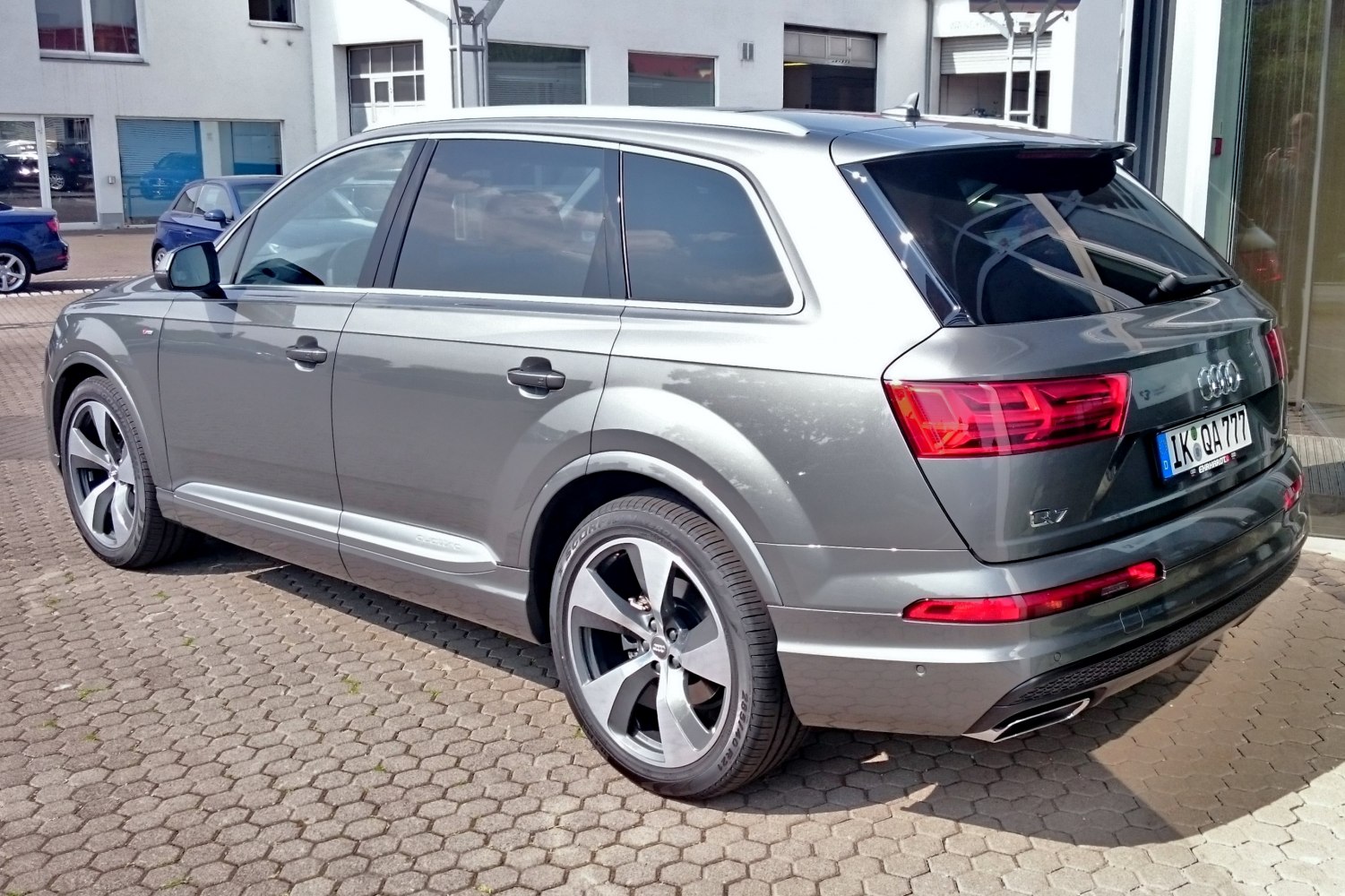 Rear side view of silver SUV with alloy wheels and tinted windows