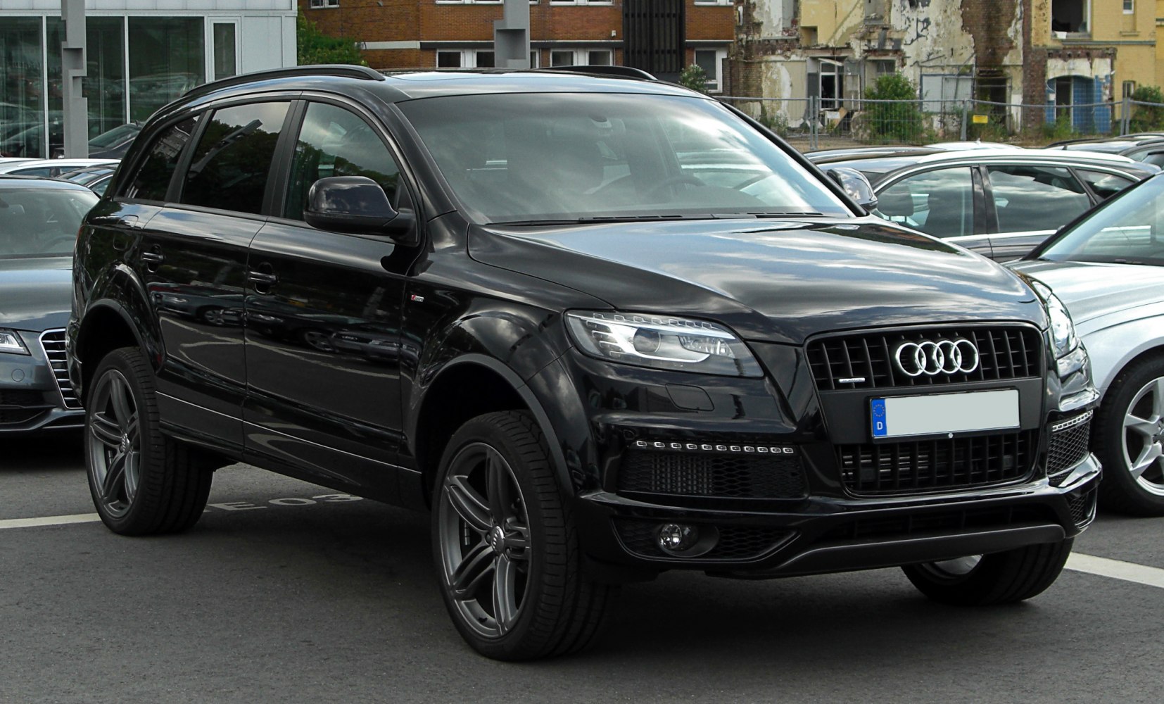 Black luxury SUV with LED headlights and large front grille.
