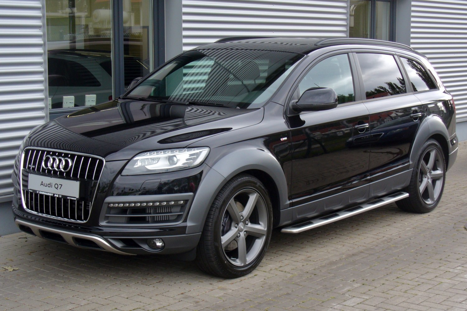 Front grille, headlights, alloy wheels, running boards of black SUV