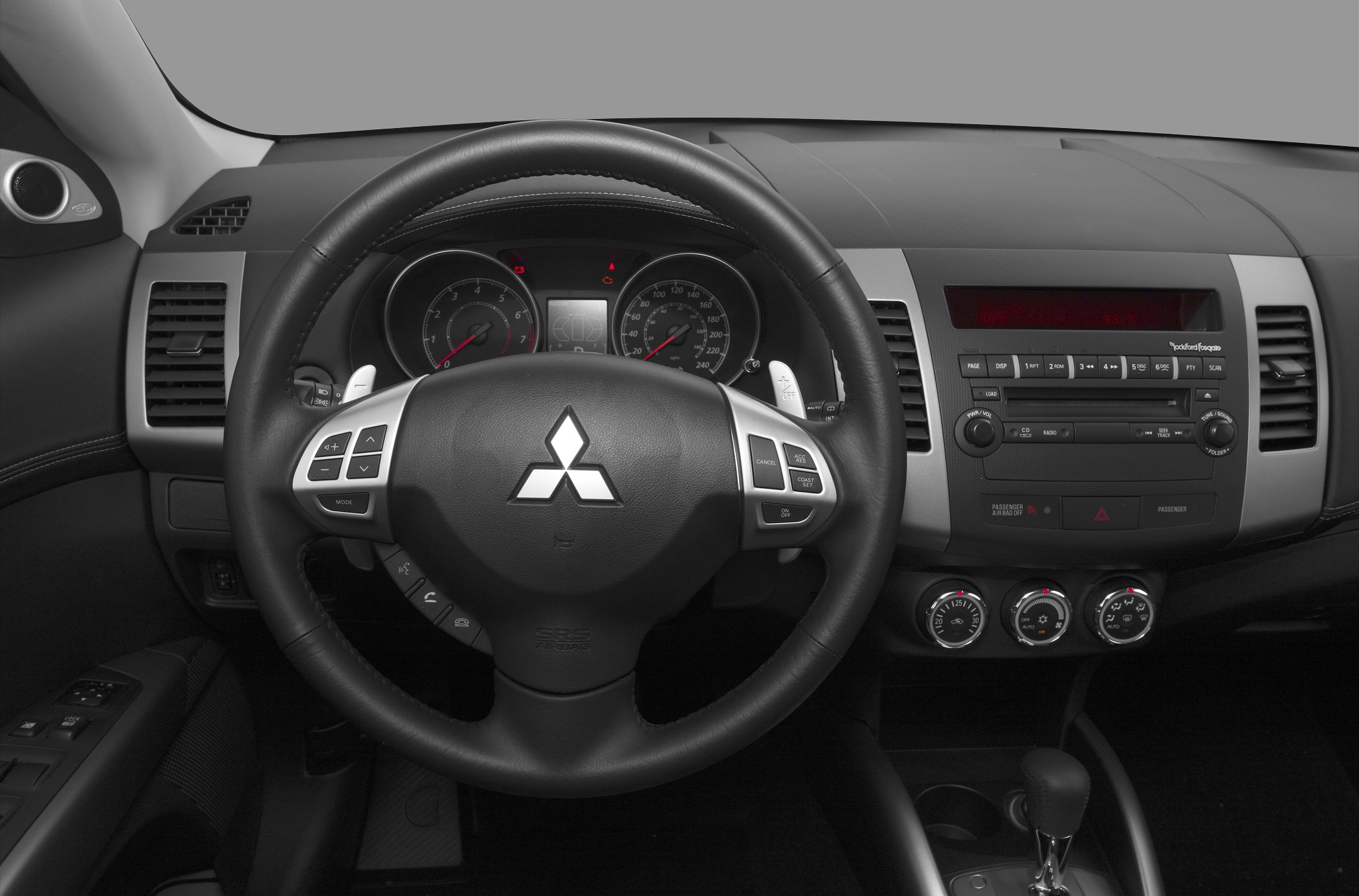 Steering wheel and dashboard with climate controls and radio panel