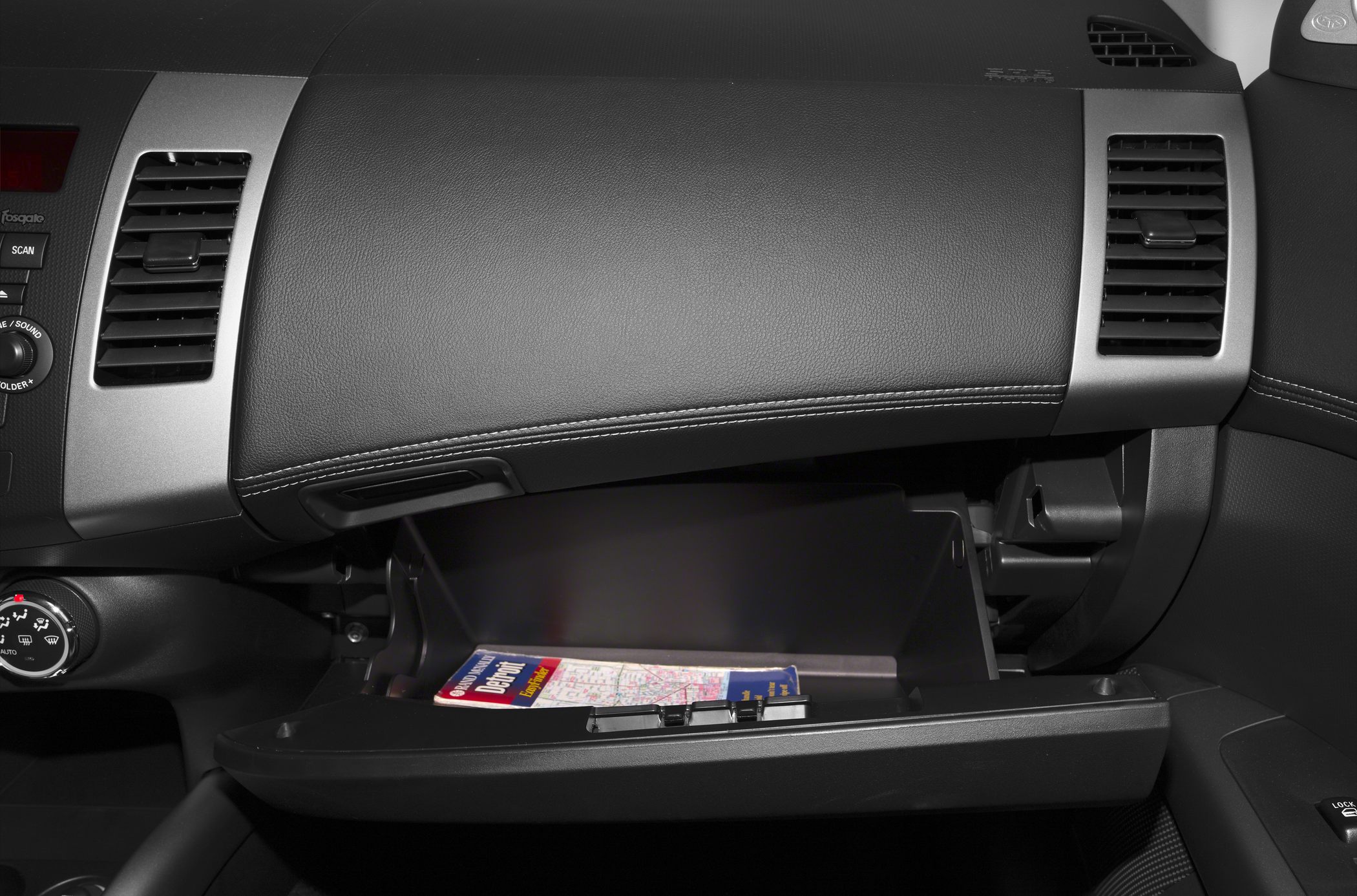 Open glovebox and dashboard vents in car interior