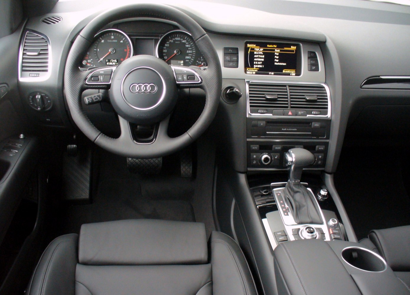 Audi Q7 interior with steering wheel and dashboard controls