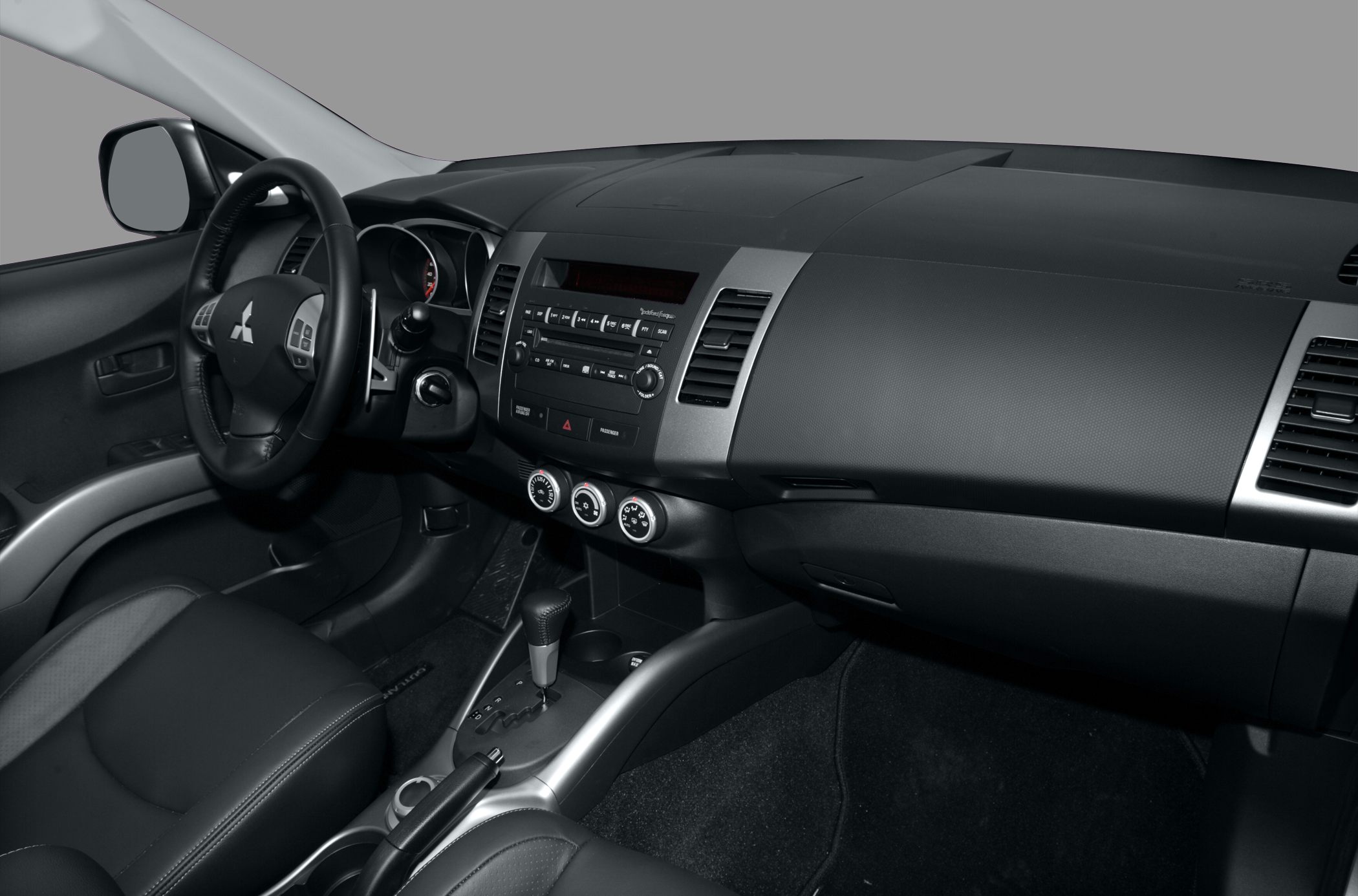 Interior dashboard with steering wheel, audio system, and climate controls