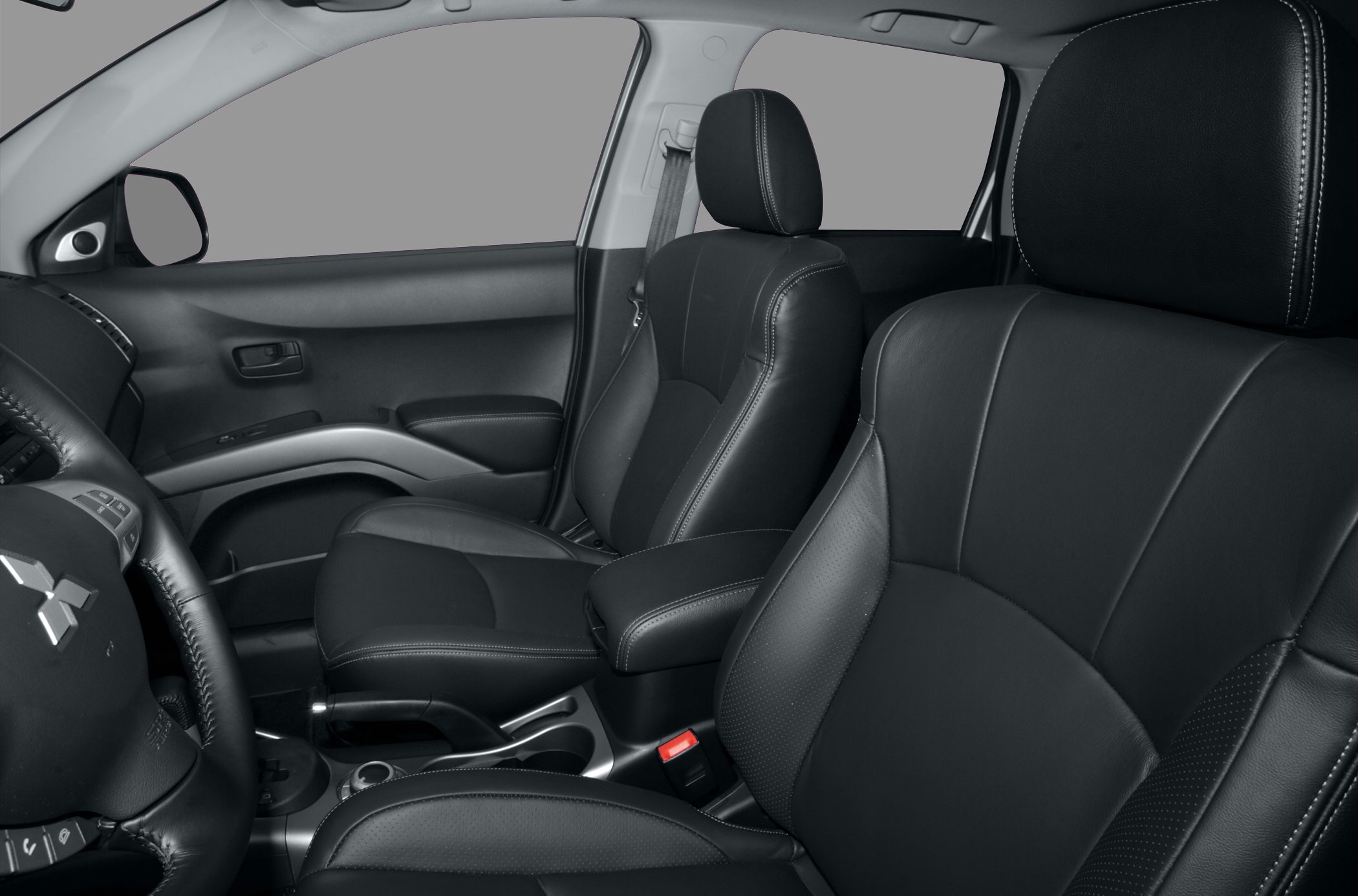 Black leather front seats and dashboard with steering wheel and controls