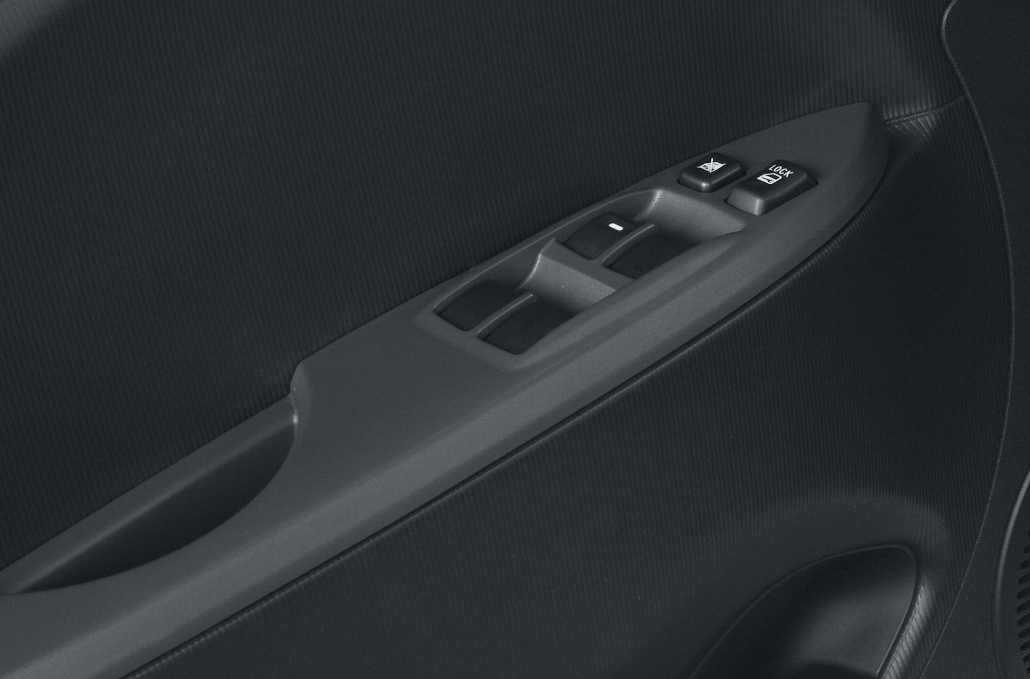 Close-up of power window and door lock controls on a car's door panel